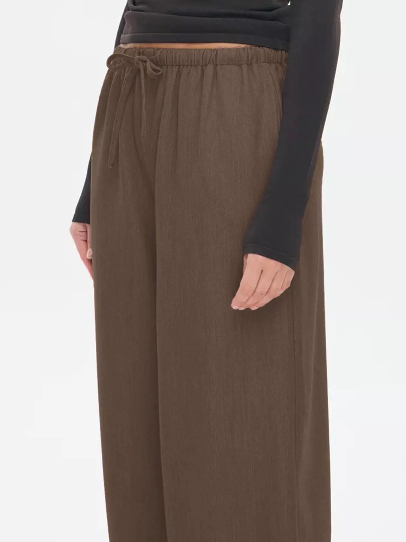 Brown wide-leg drawstring pants with elastic waist and relaxed straight-leg fit.