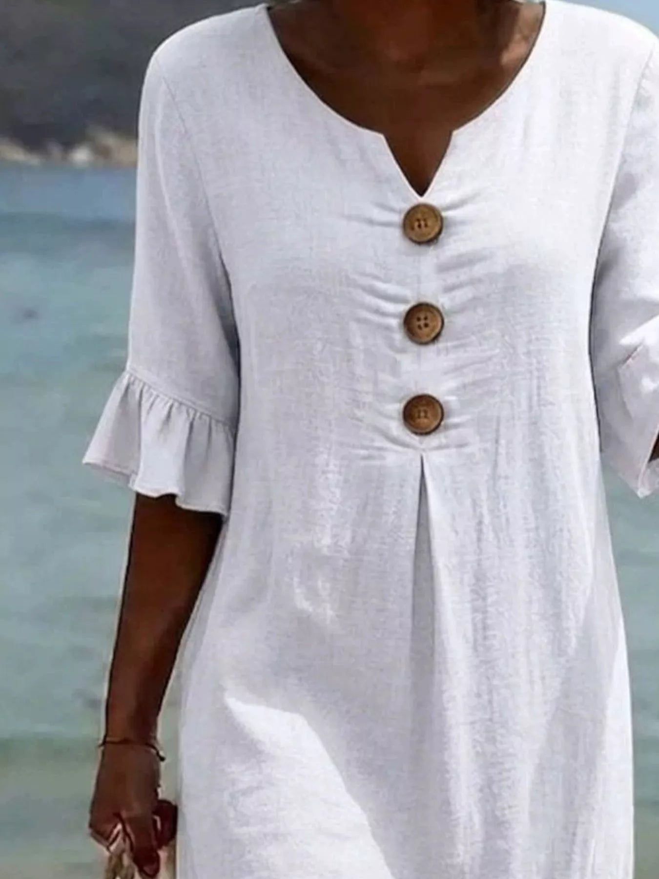 White V-neck button-front midi dress with ruffle sleeves and three wood-tone buttons
