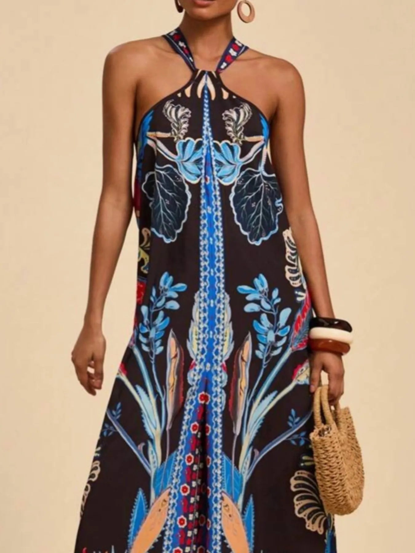 Black halter wide-leg jumpsuit with blue botanical print and vertical center stripe