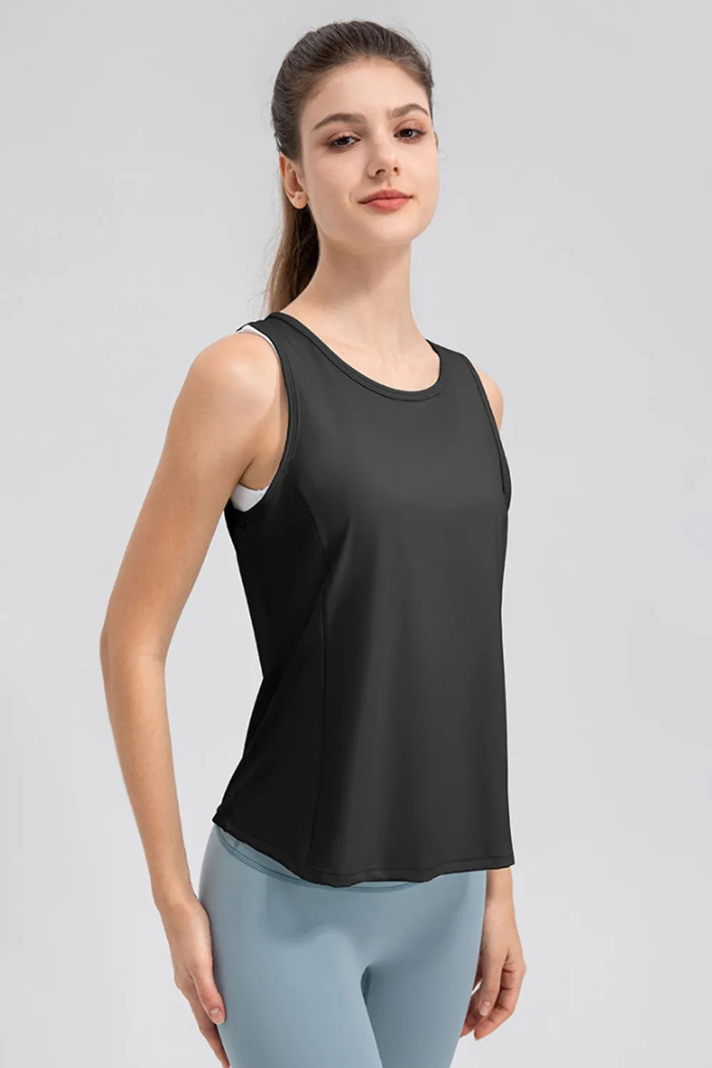 Women’s black active tank top with wide straps and curved hem