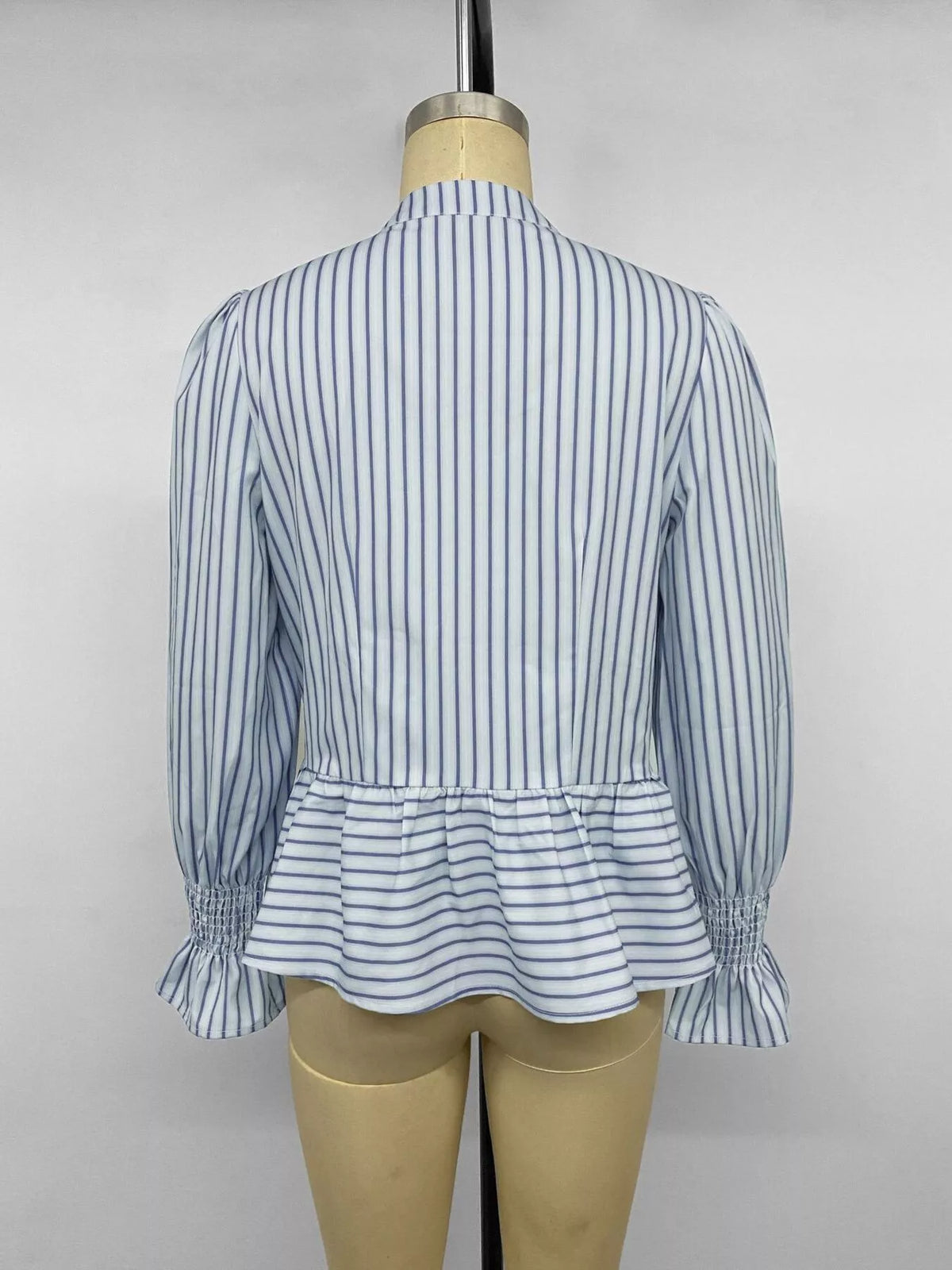 Blue striped mandarin peplum shirt, back view with ruffled hem