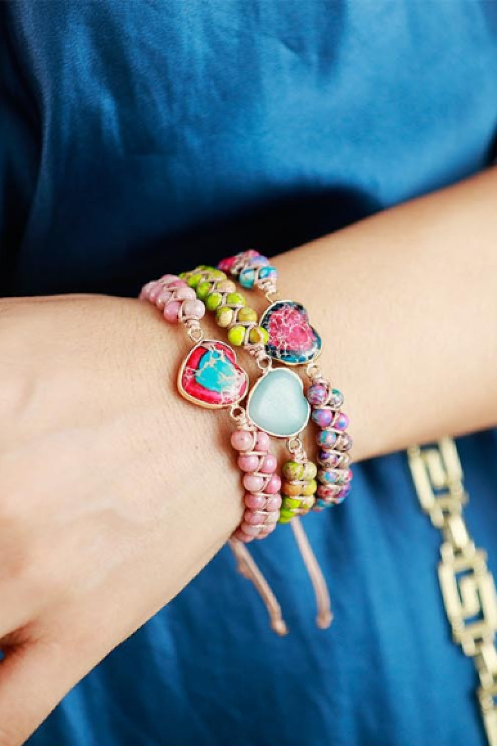 Set of pink and multicolor beaded bracelets with heart-shaped and oval stone charms