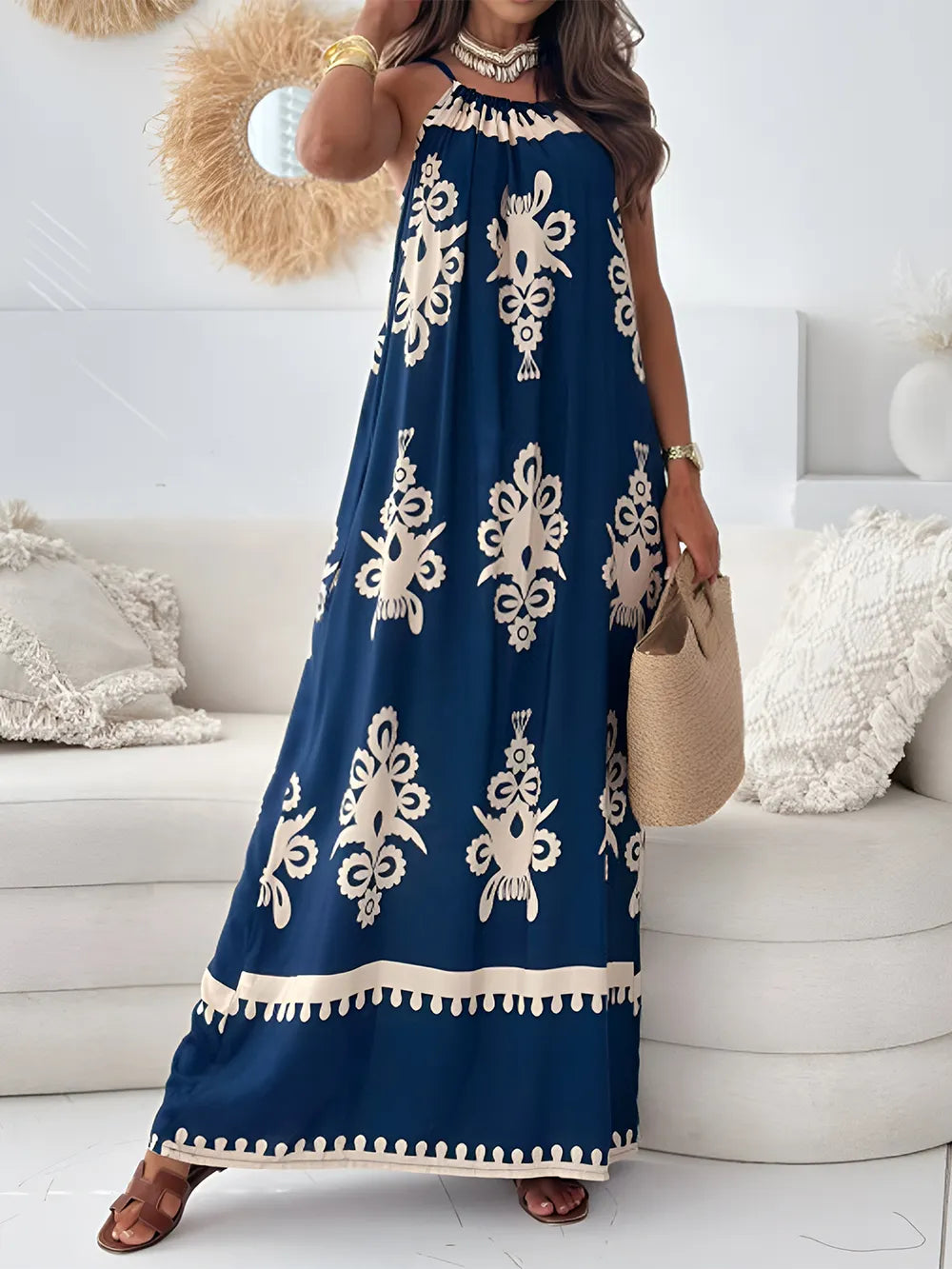 Navy printed maxi dress with spaghetti straps, ruffled neckline, and cream floral motifs