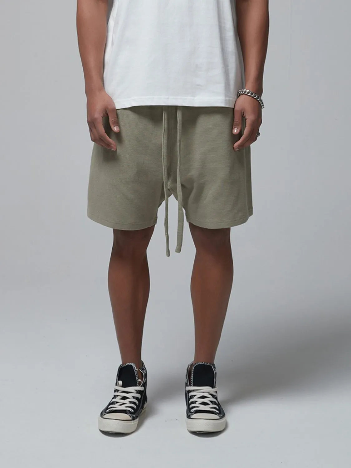 Men's sage waffle shorts with drawstring tie and side pockets, knee-length
