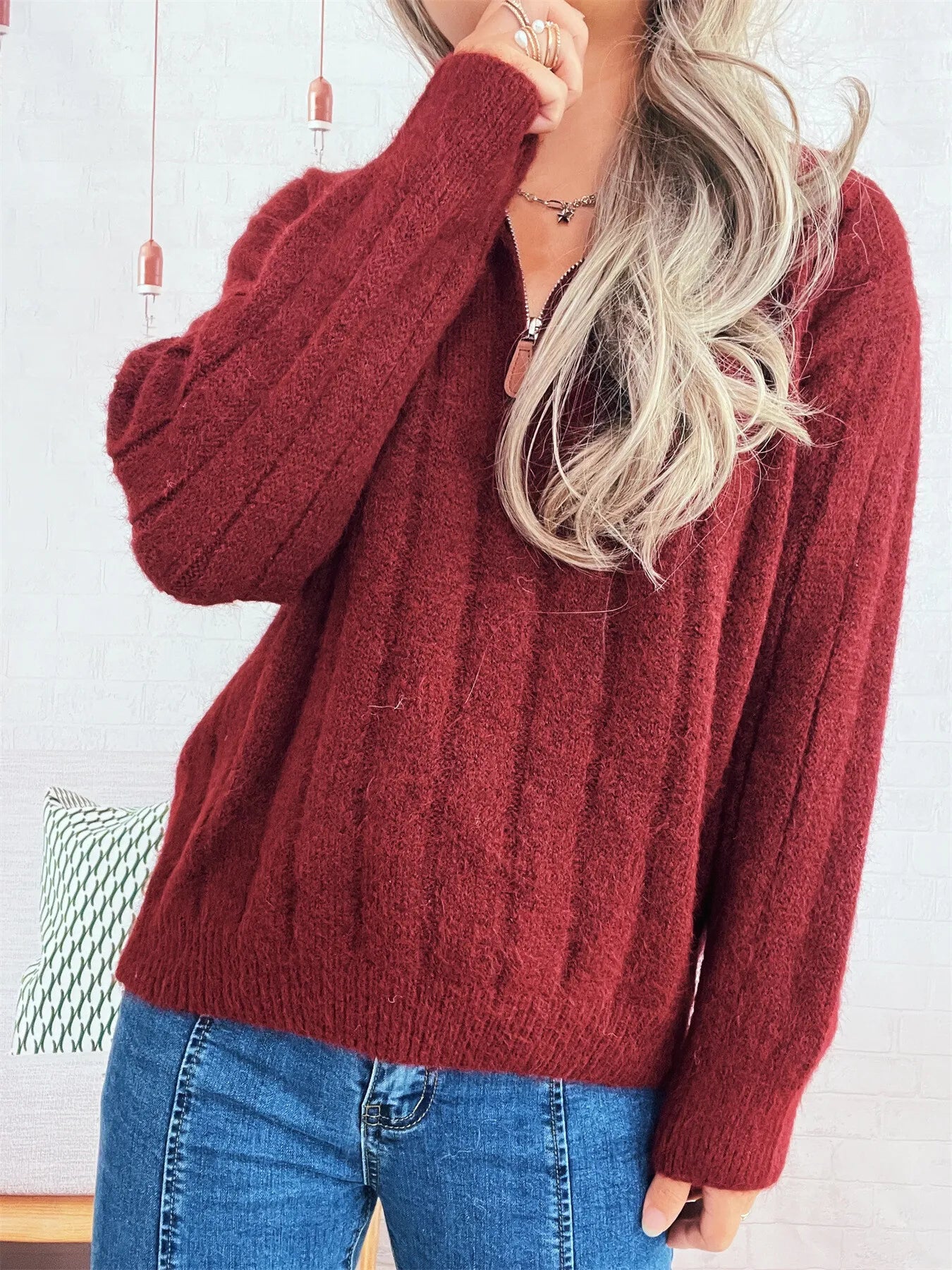 Ribbed hem quarter-zip sweater, burgundy long-sleeve with half-zip placket.