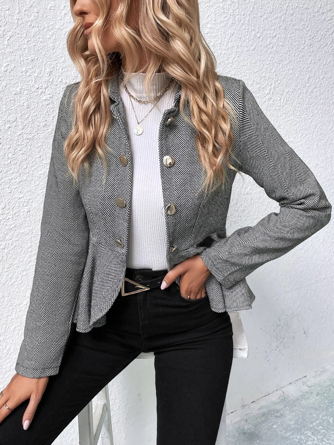 Gray collared peplum blazer with ruffle hem, gold buttons, and textured weave