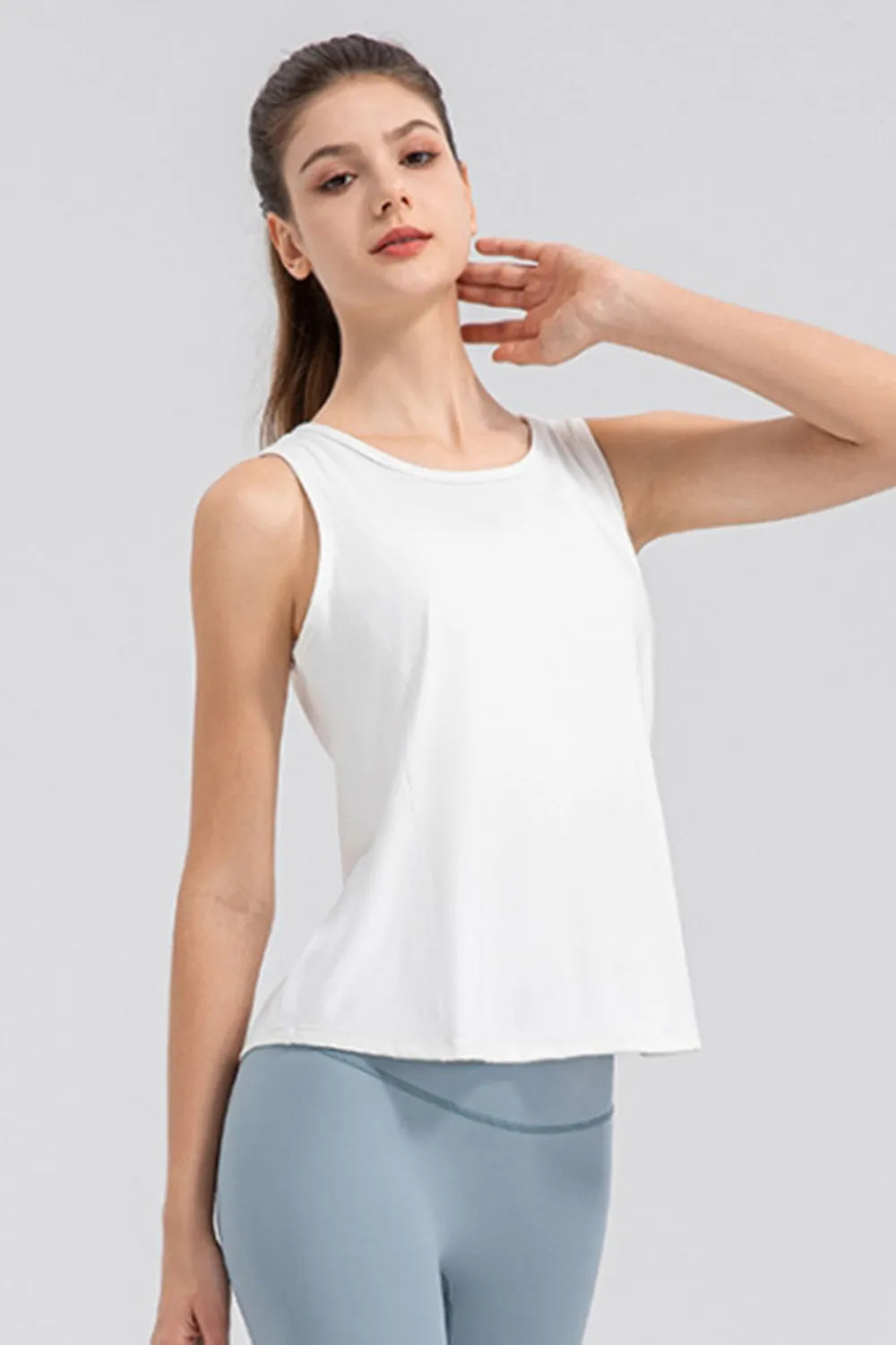 White active tank top with wide straps and round neckline, side pose.