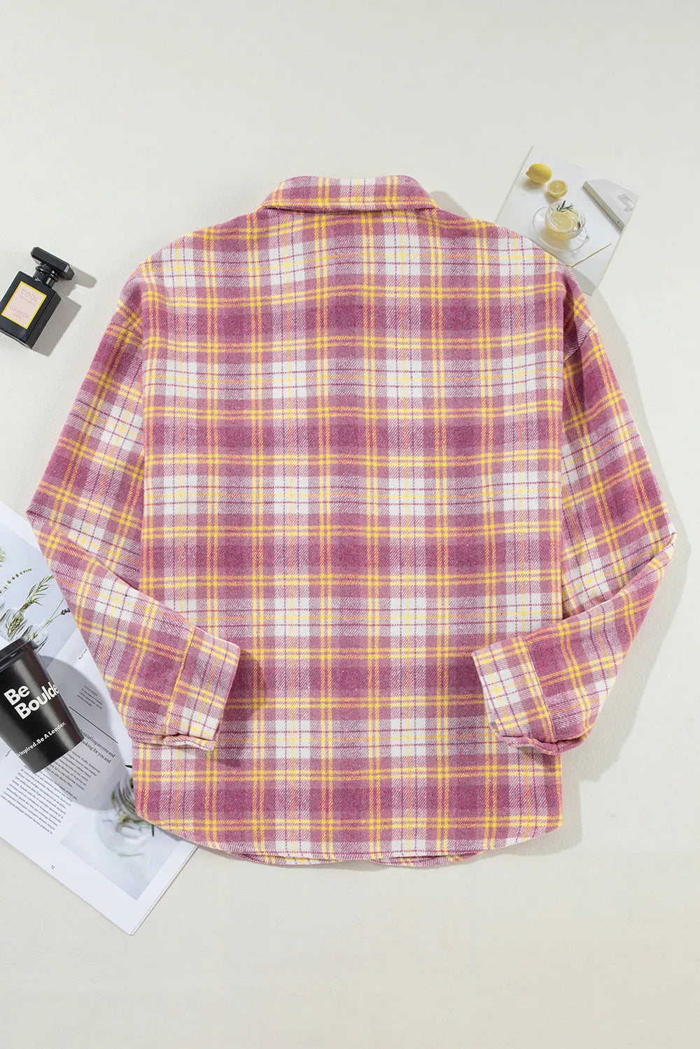 Pink plaid shacket laid flat, showing back view and yoke seam