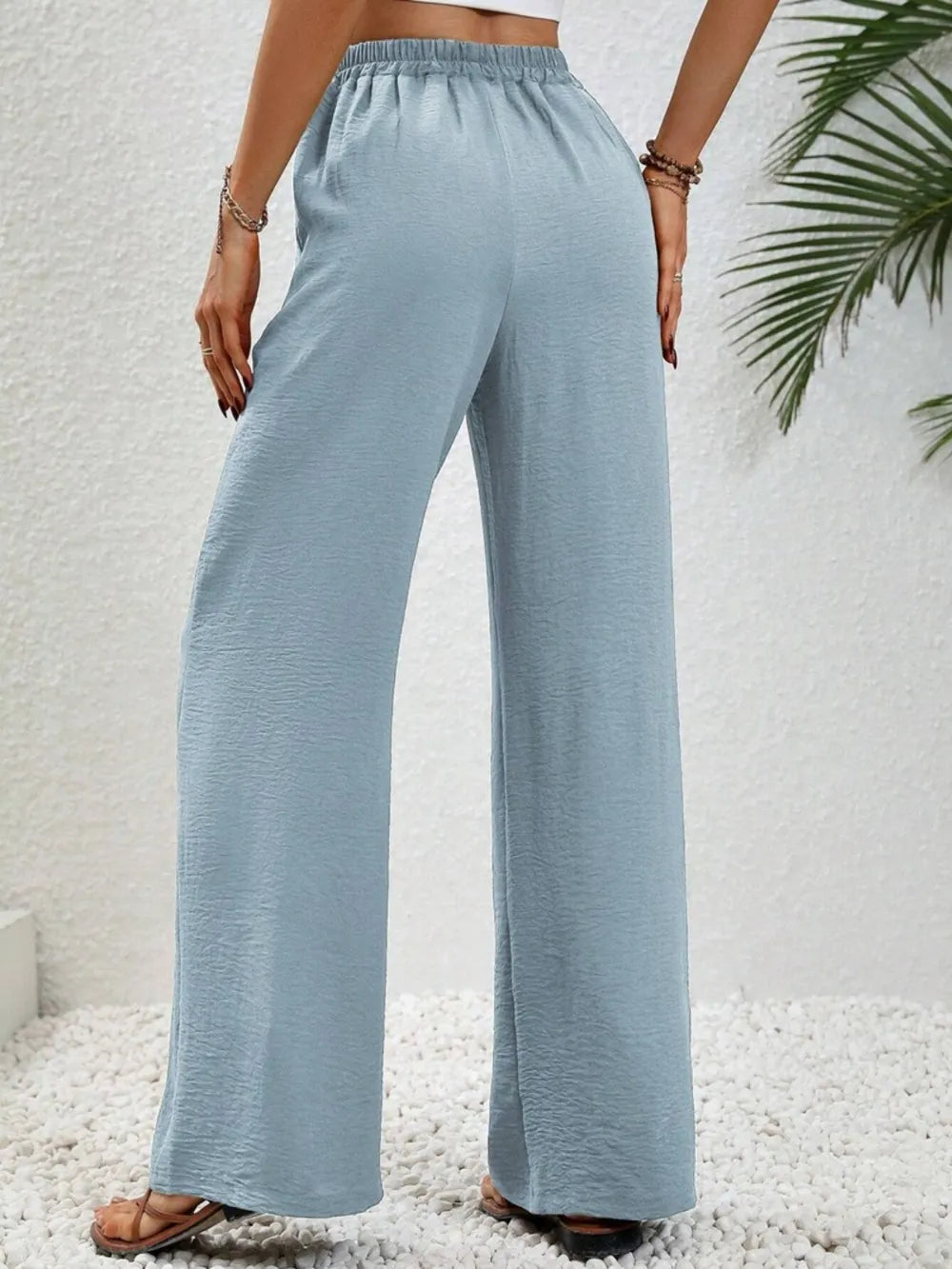 Light blue wide-leg drawstring pants with elastic waistband and loose flowy legs