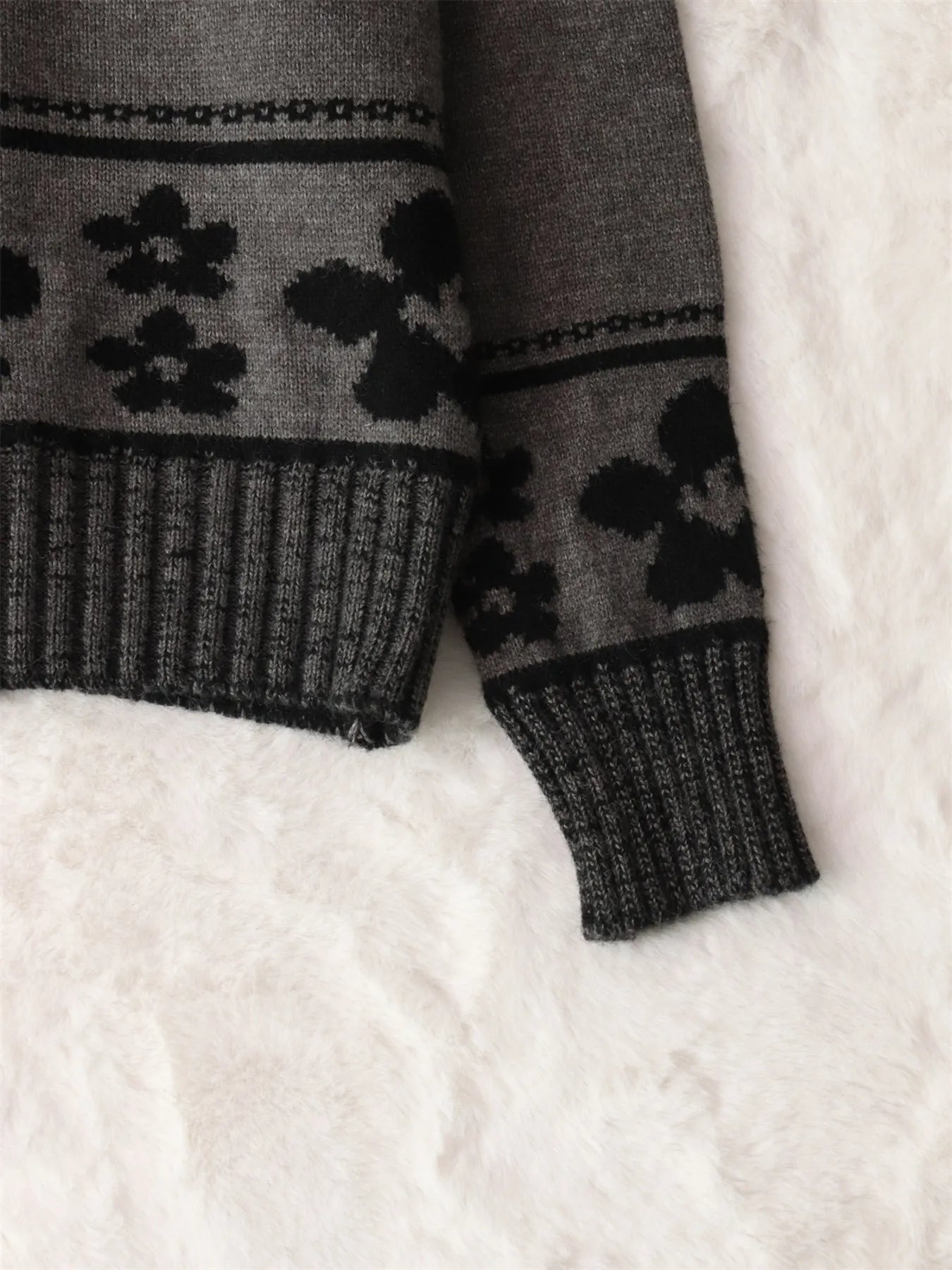 Gray sweater close-up of black floral band hem and ribbed knit cuffs
