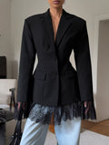 Black women’s blazer with lace-trim hem and flap pockets, single-button front.