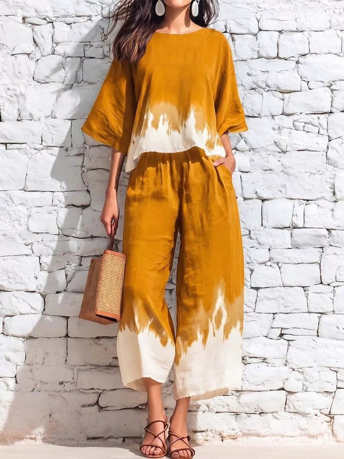 Orange tie-dye two-piece set with loose top and capri pants, white splash pattern