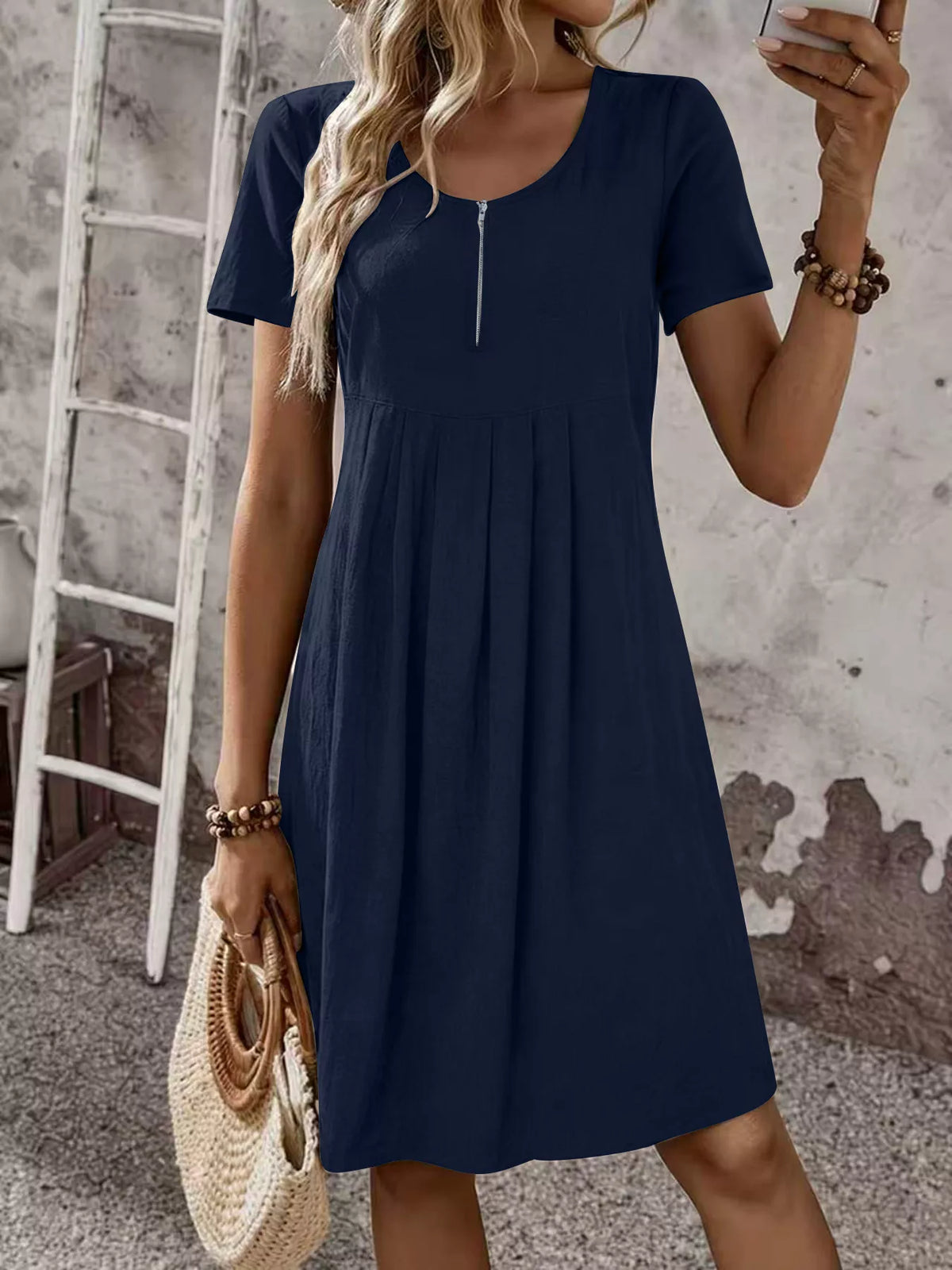 Navy blue zip-front pleated short-sleeve dress with scoop neckline