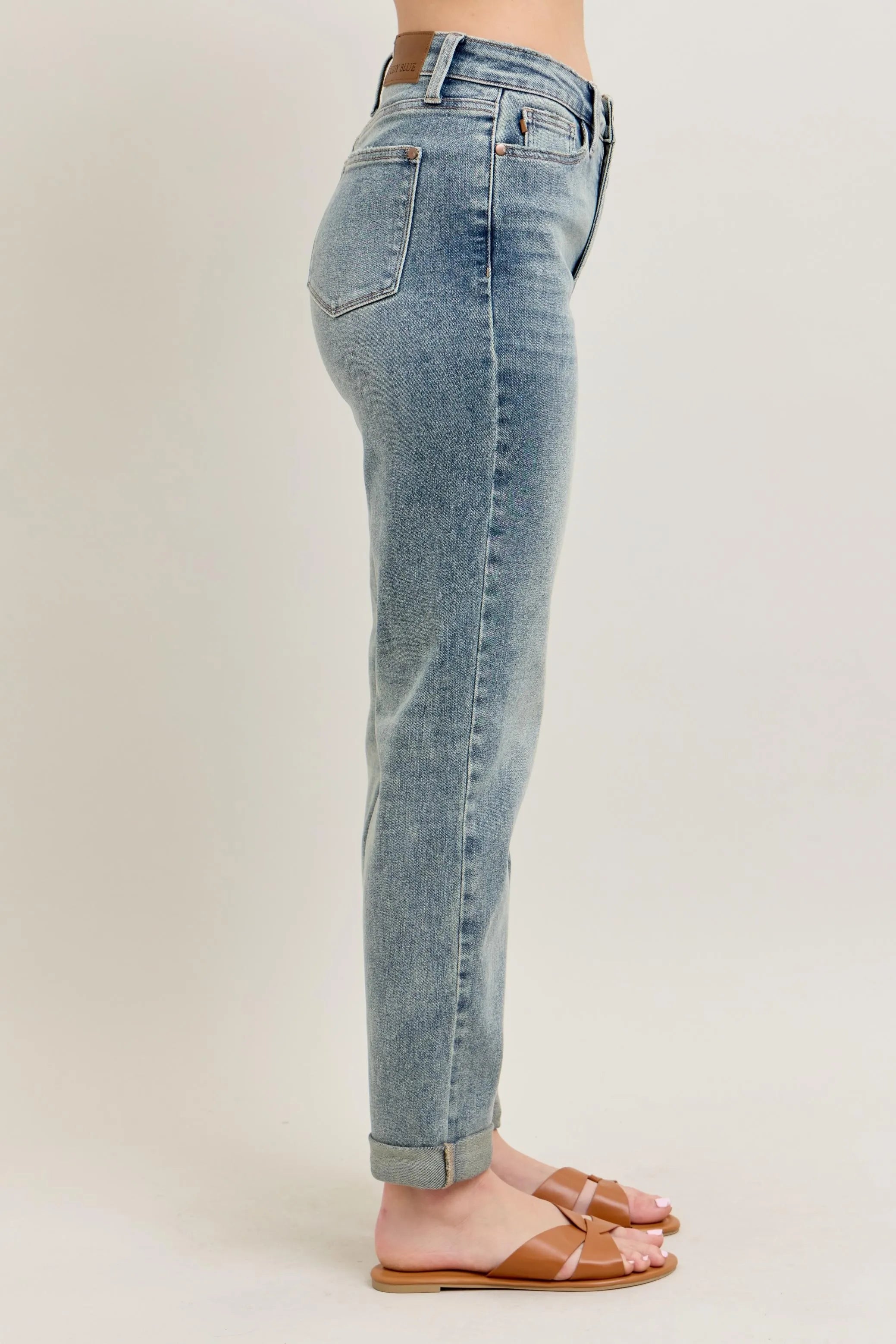 Light blue vintage-wash jeans side view with back pockets and roll cuff