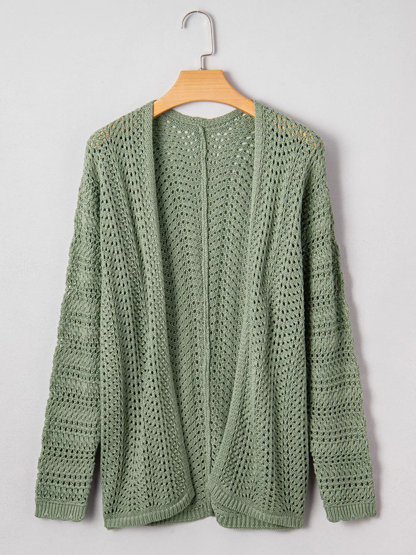 Sage eyelet knit cardigan with long sleeves and openwork texture, back view.
