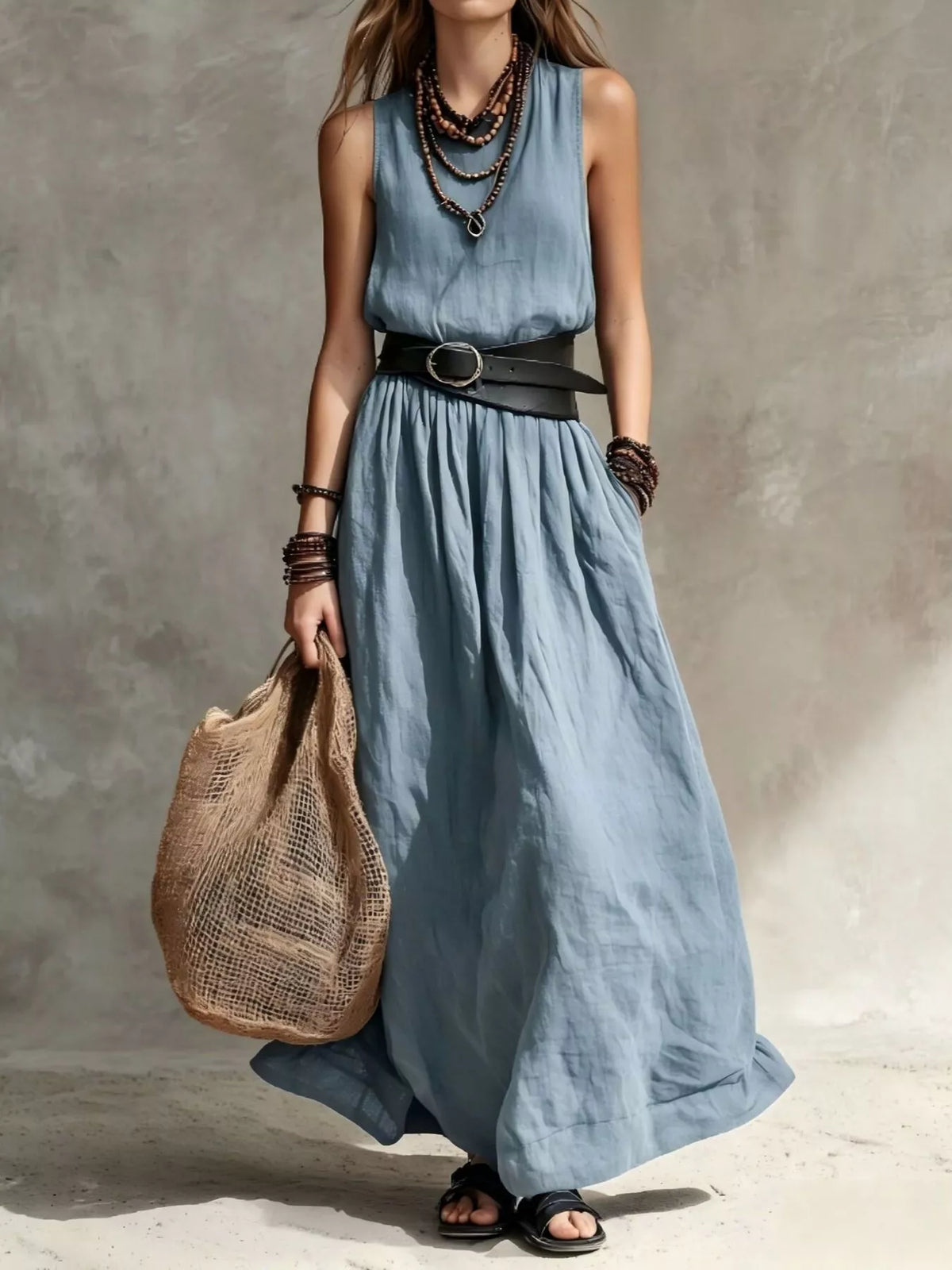 Blue belted sleeveless maxi dress with round neckline and gathered, flowy skirt