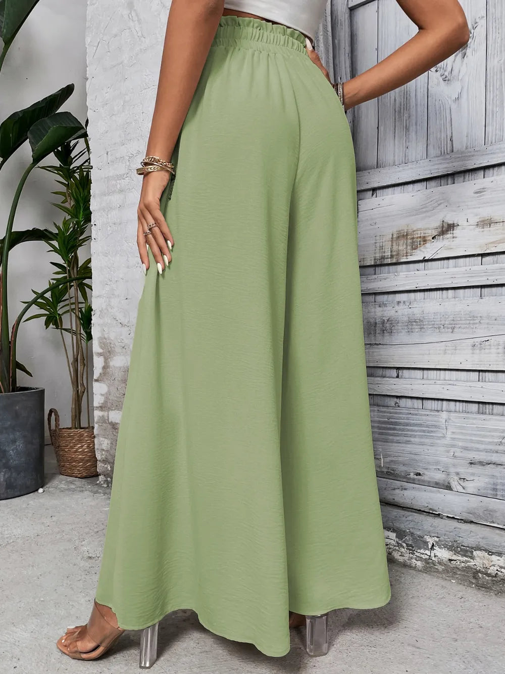 High-waist wide-leg pants in light green with elastic waistband and drawstring tie