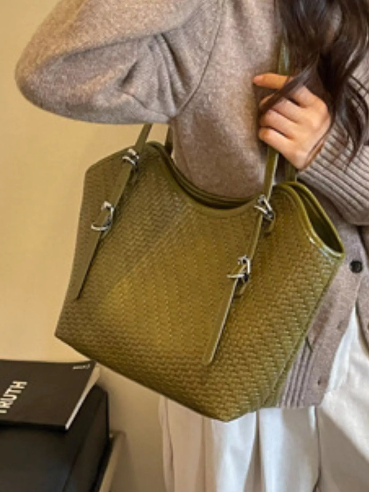 Green textured tote bag with side panel, top handles, and zipper front pocket
