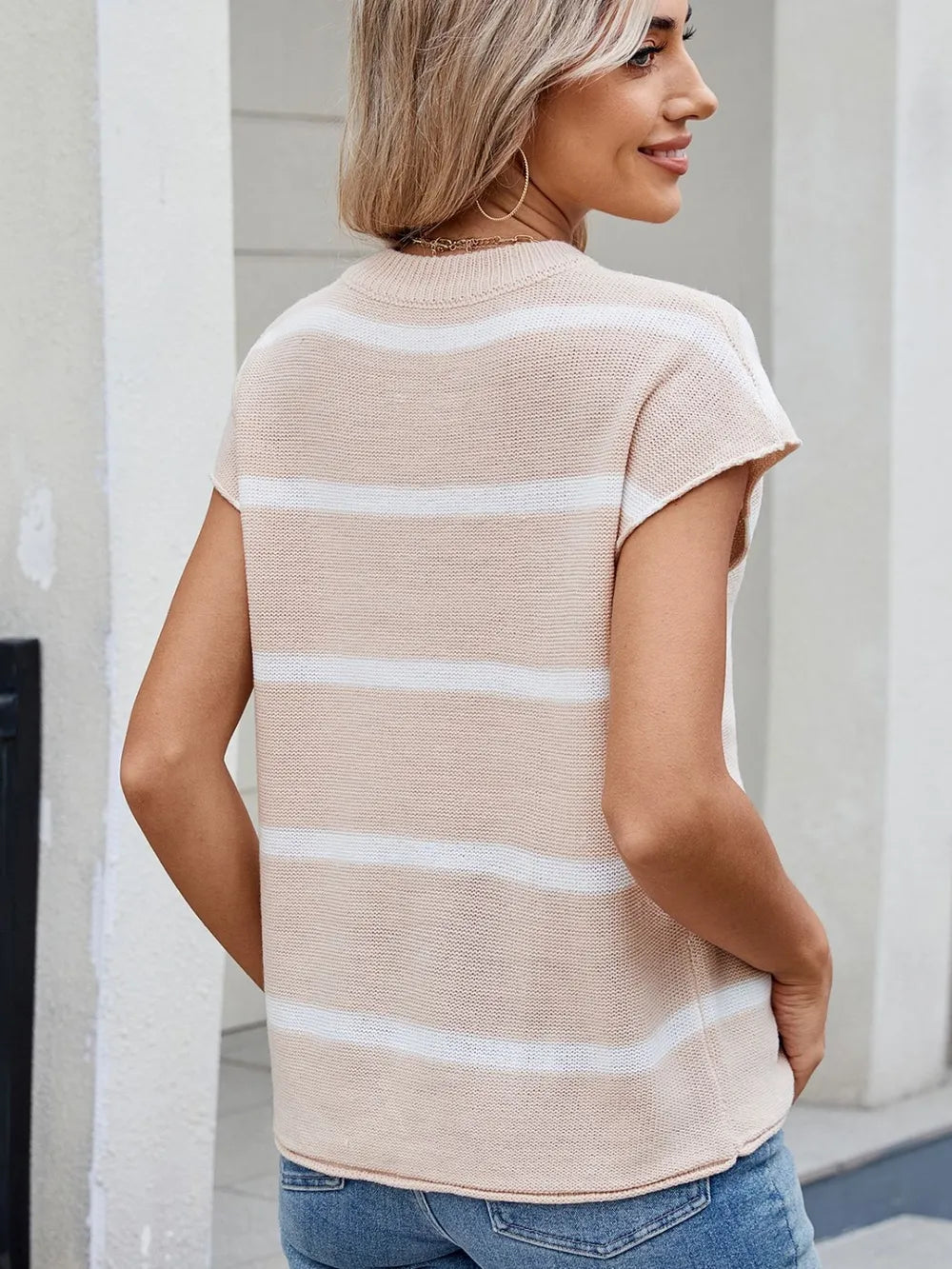 Back view of beige striped knit top with round neck and exposed center seam
