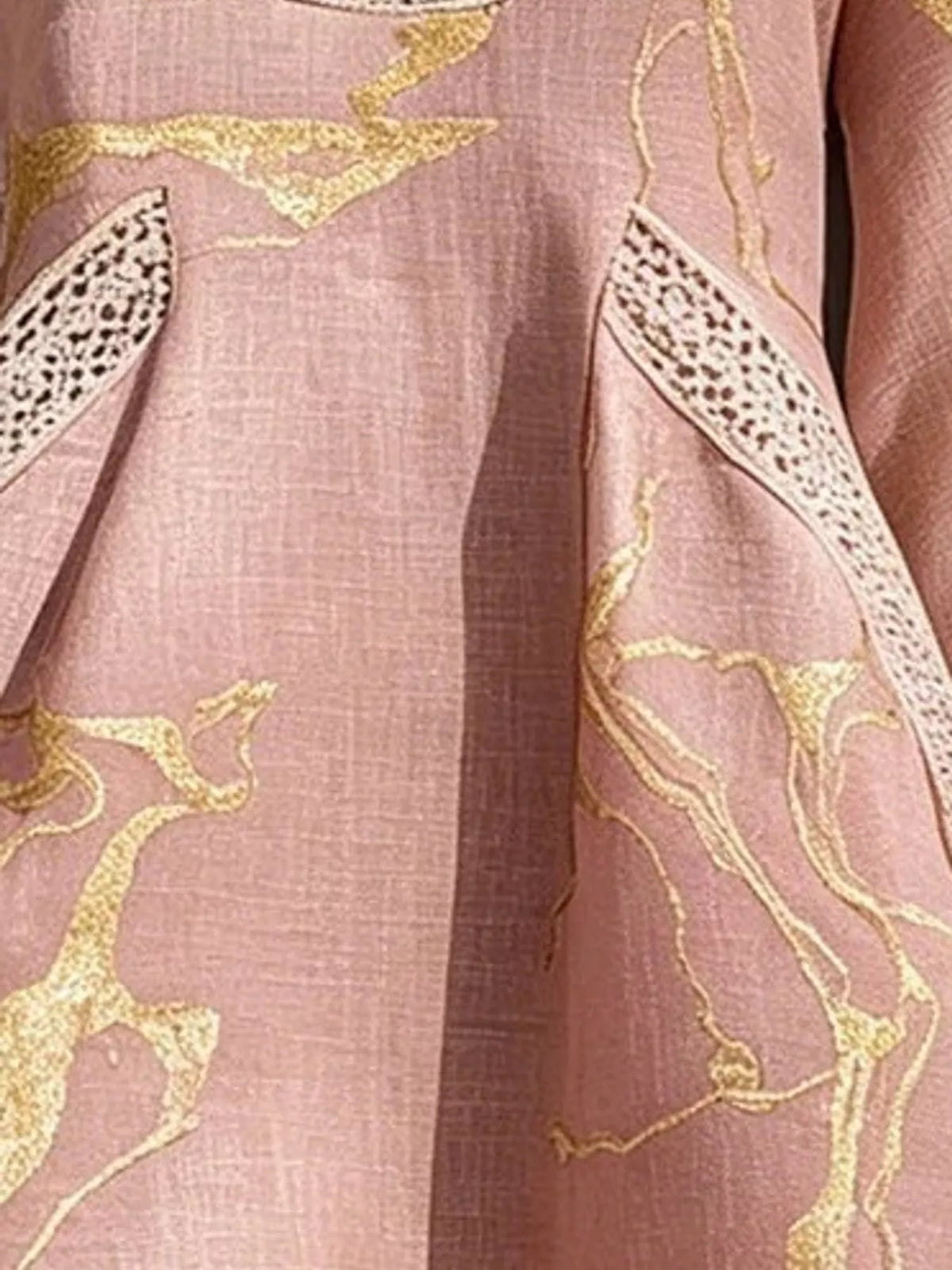 Pink mini dress fabric close-up with gold horse-print design and lace trim edge