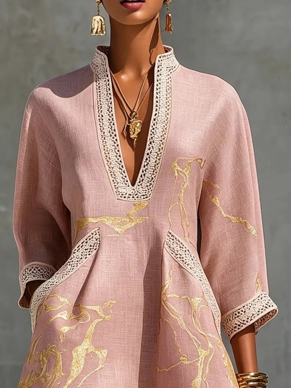 Pink relaxed-fit mini dress with notched V neckline, lace trim edges, and gold horse-print