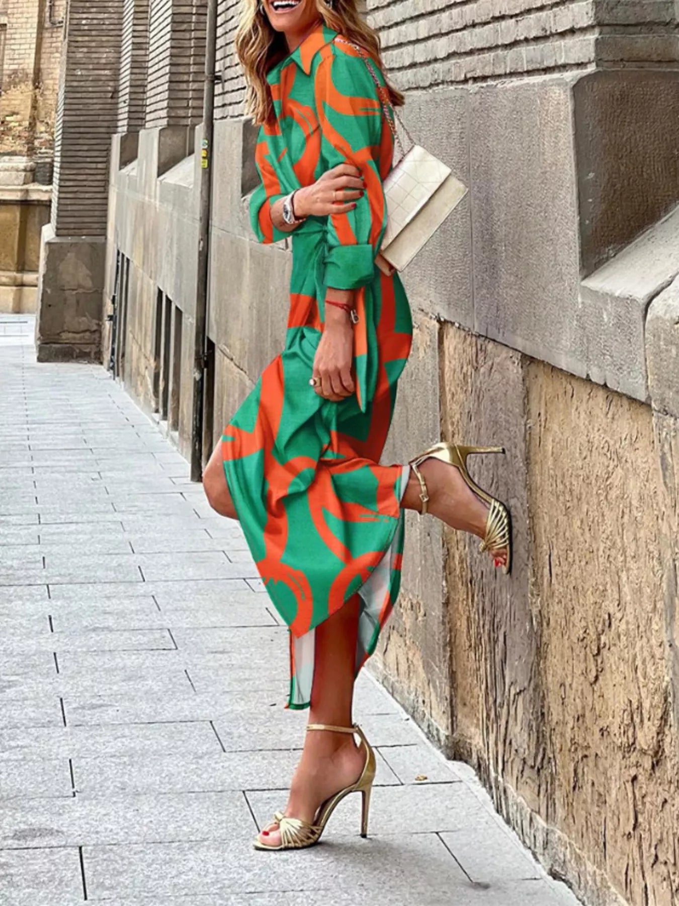 Teal wrap midi dress with orange abstract print and tied waist belt, 3/4 sleeves
