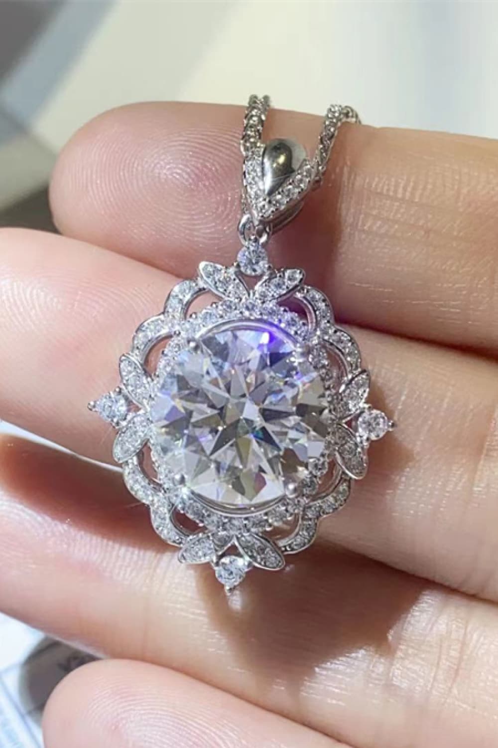 Round moissanite pendant necklace in sterling silver with detailed halo and prongs