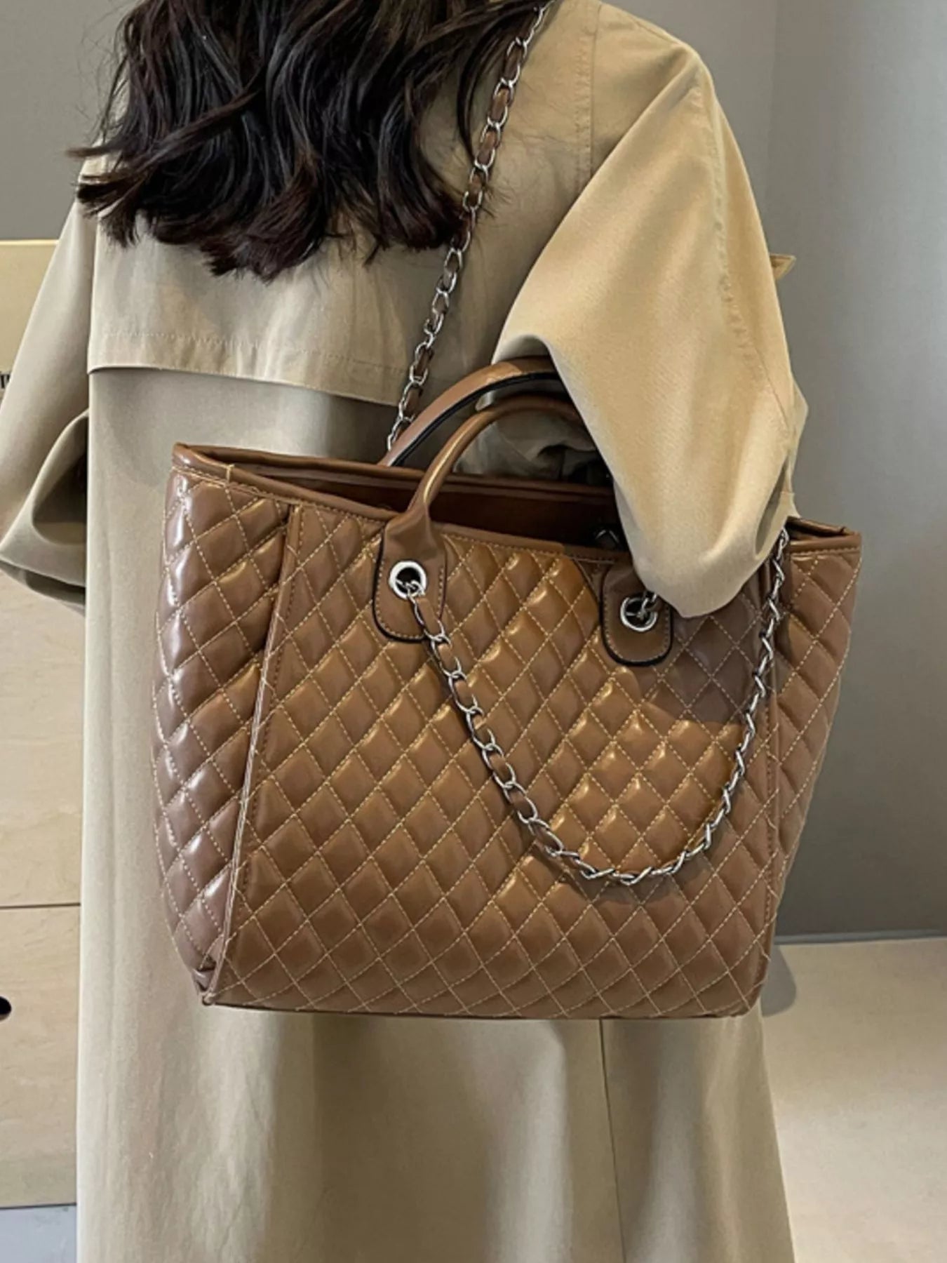 Brown quilted medium shoulder bag with chain strap and double top ring hardware