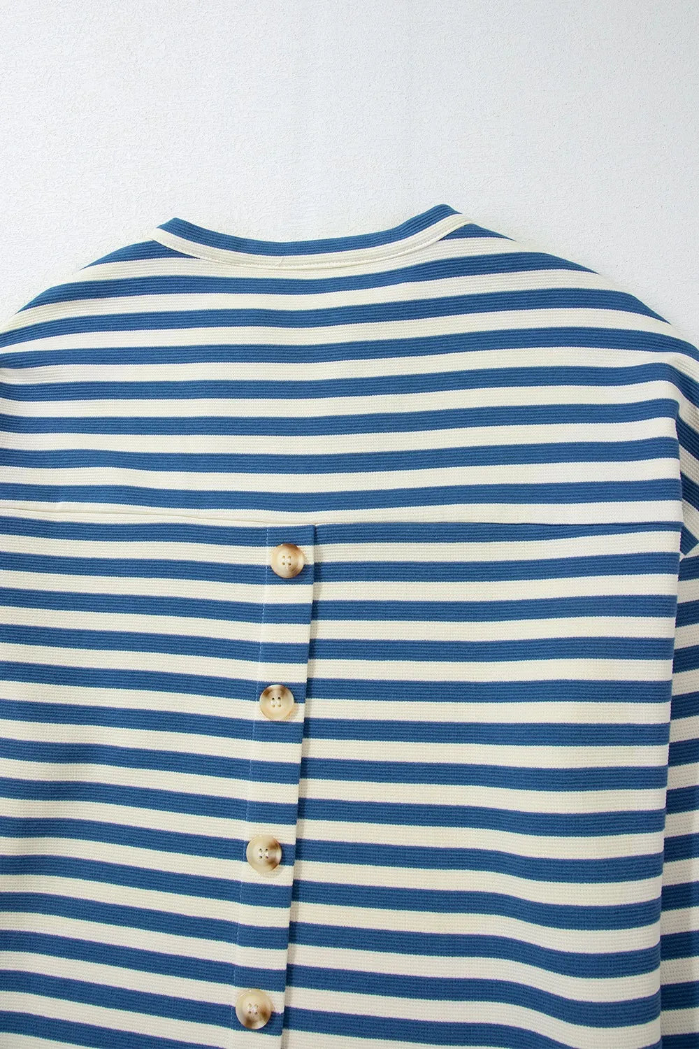 Blue and white striped top with vertical button placket at back