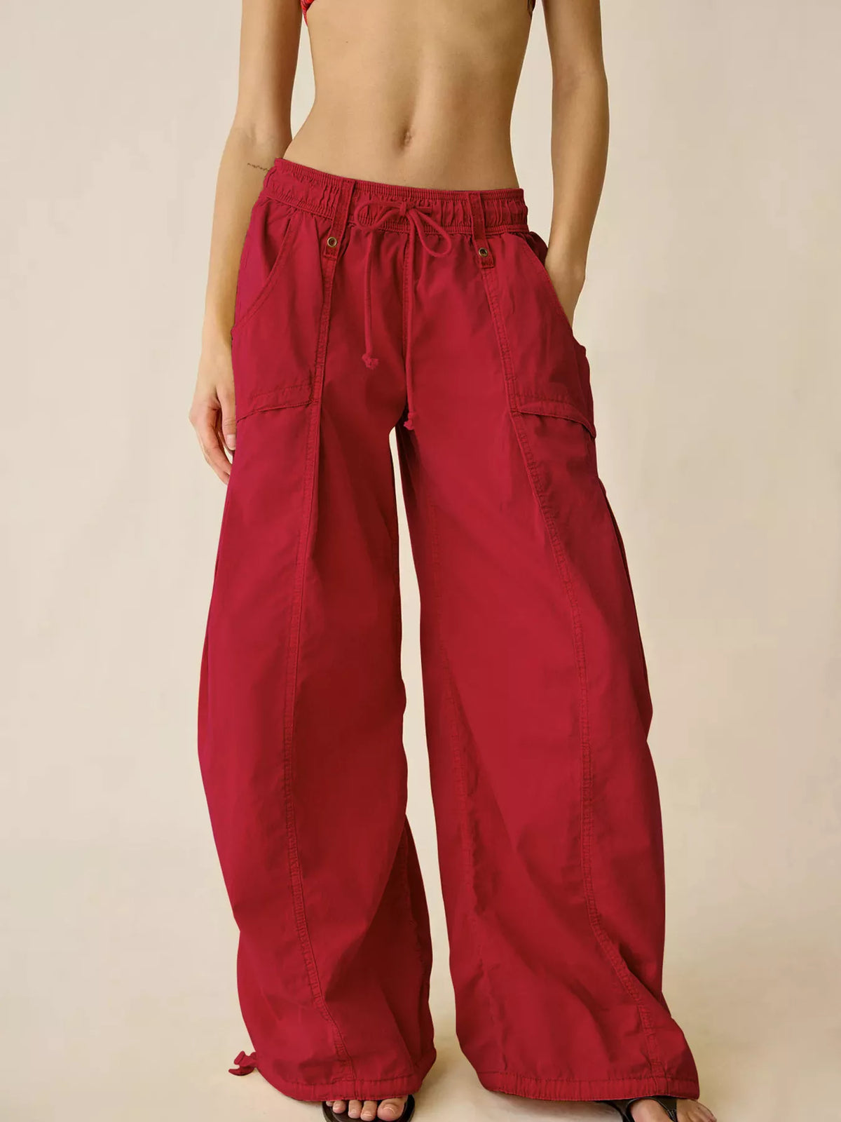 Red high-waisted cargo wide-leg pants with drawstring waist and side cargo pockets