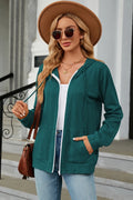 Turquoise drawstring zip-up hoodie with hood, white-trim zipper, and front kangaroo pocket