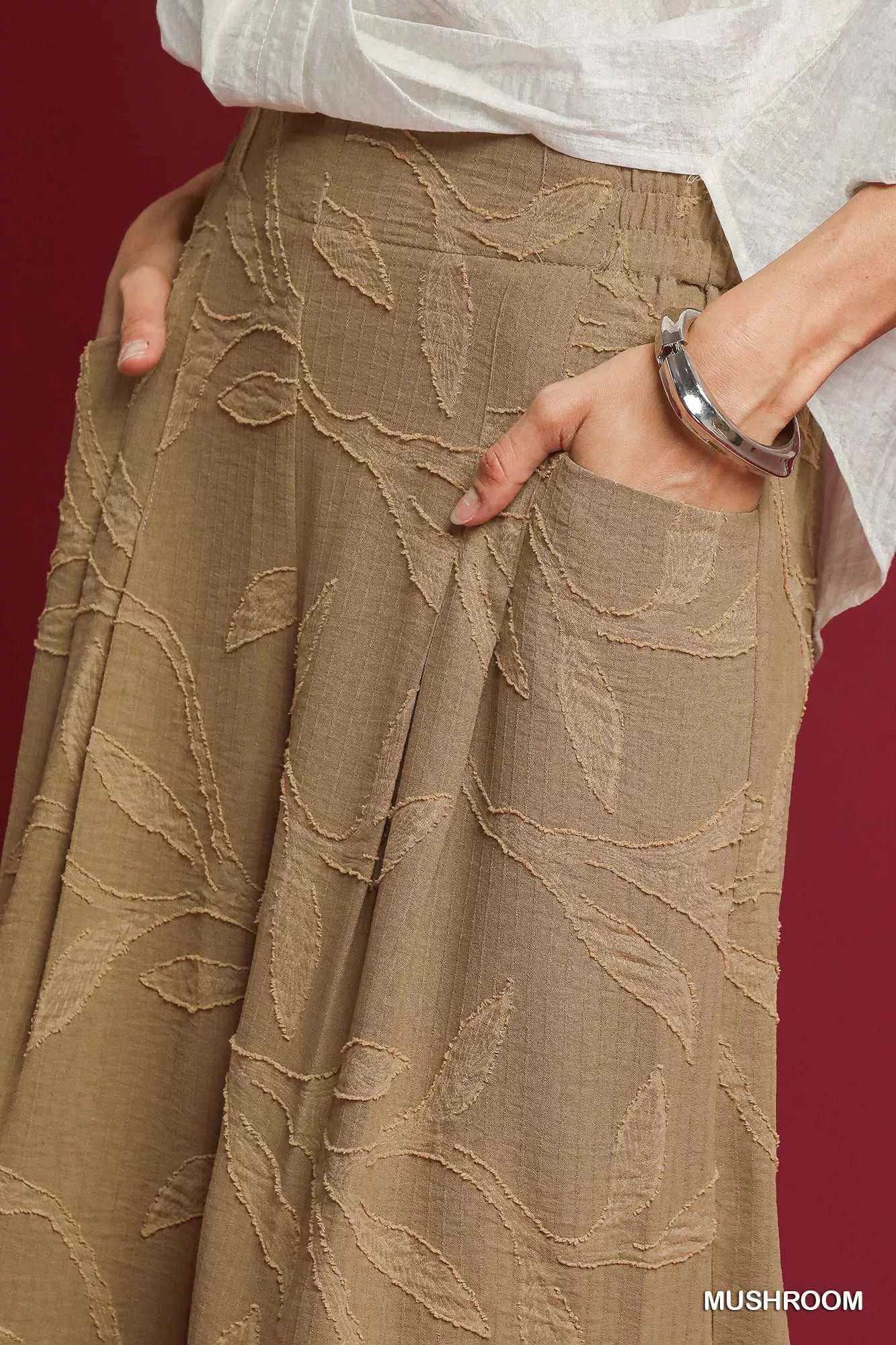 Mushroom jacquard wide-leg pants close-up of vine-like textured fabric