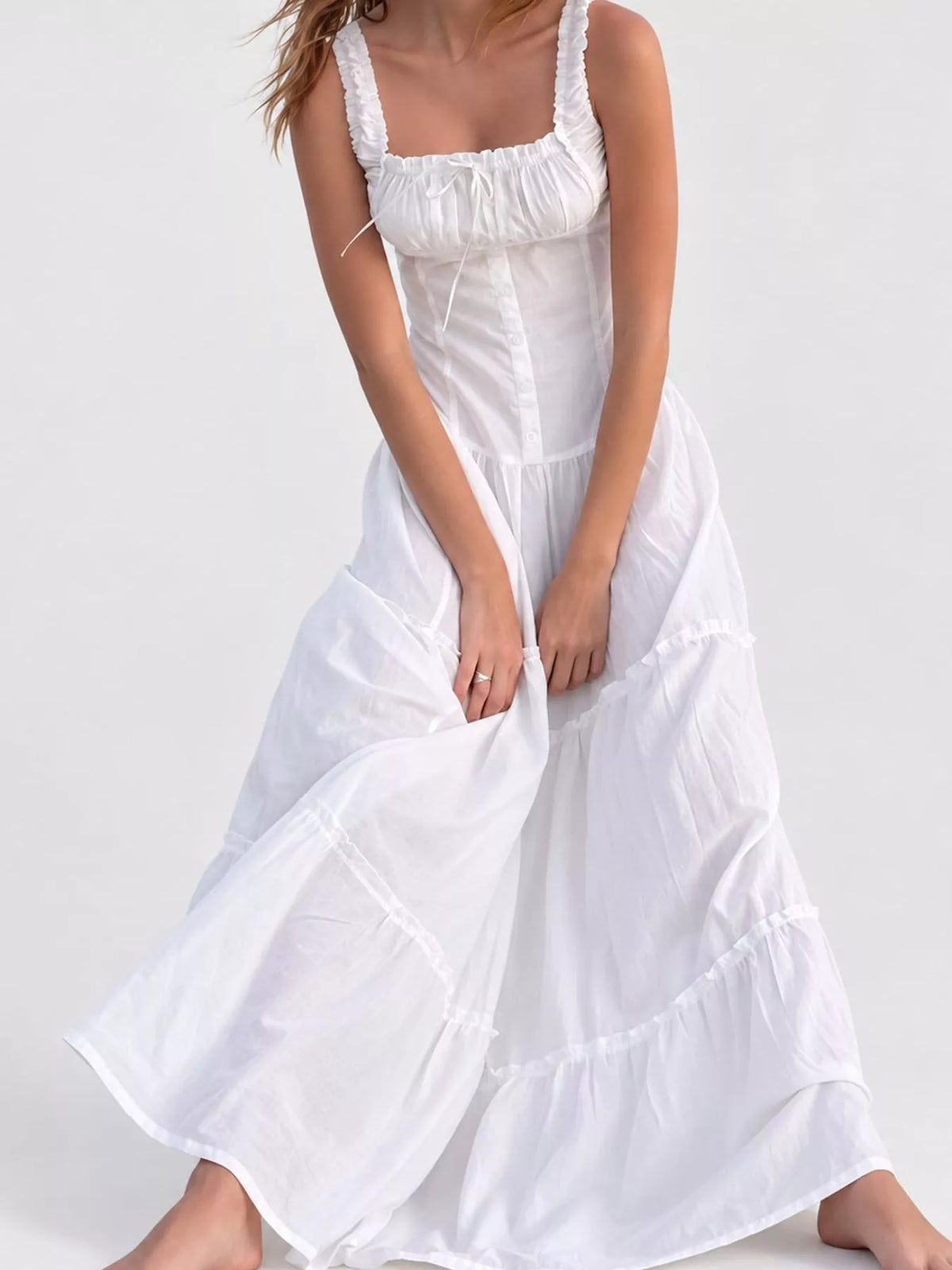 White cotton maxi dress with ruffled square neck, smocked bodice, tiered skirt