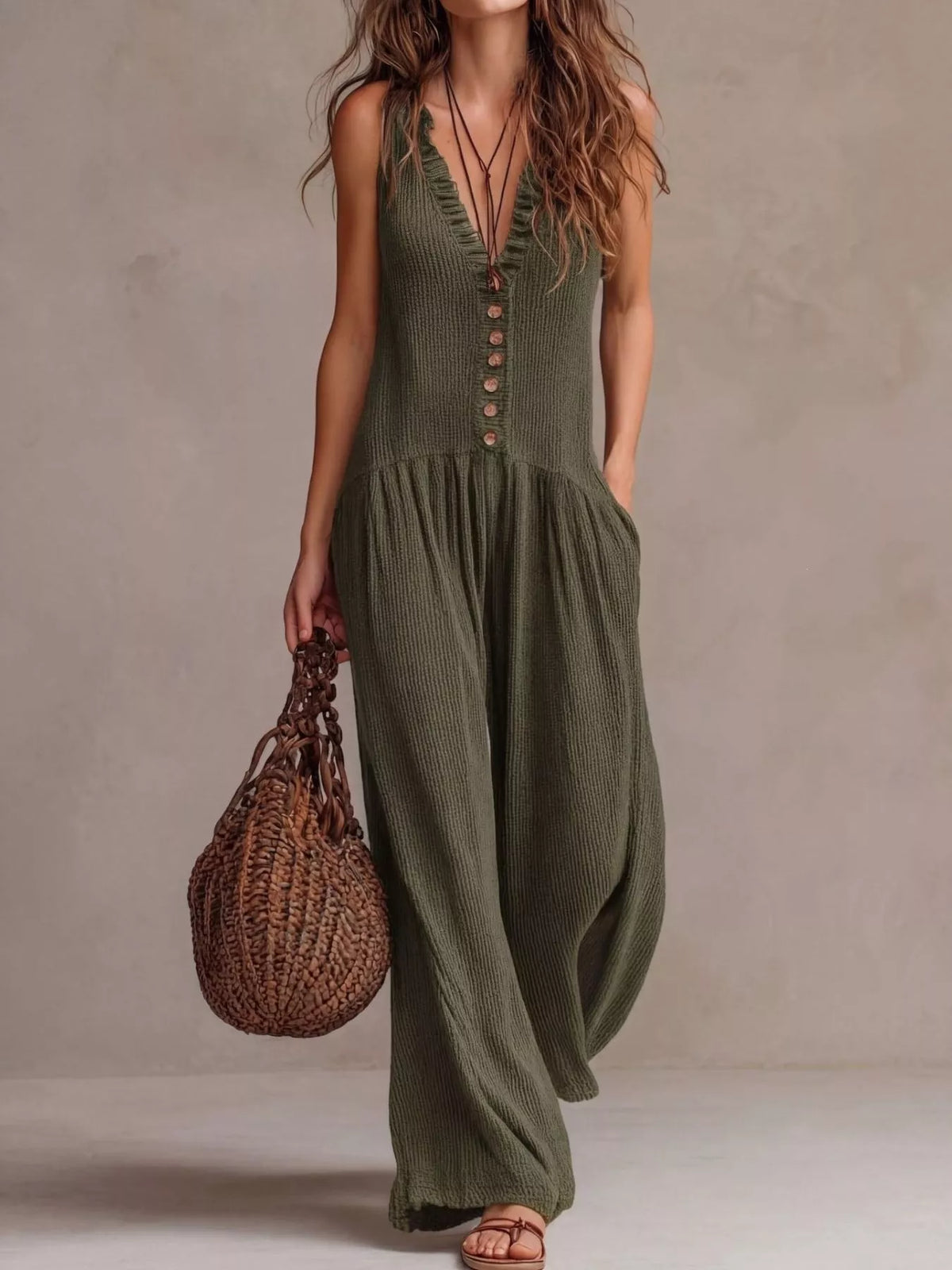 Moss green sleeveless V-neck jumpsuit with front buttons and wide balloon legs