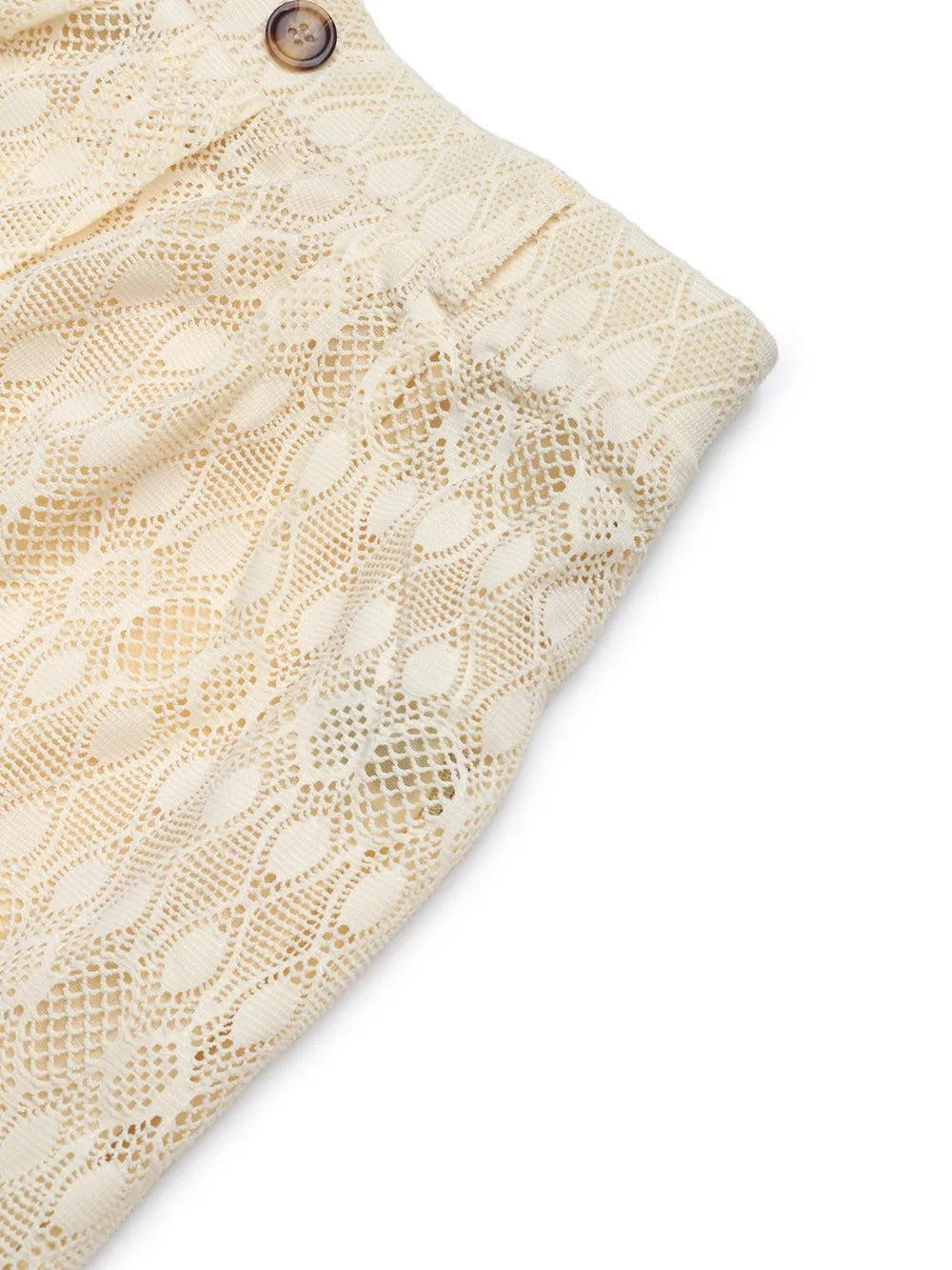 Cream lace fabric with openwork geometric pattern and round button detail at waistband