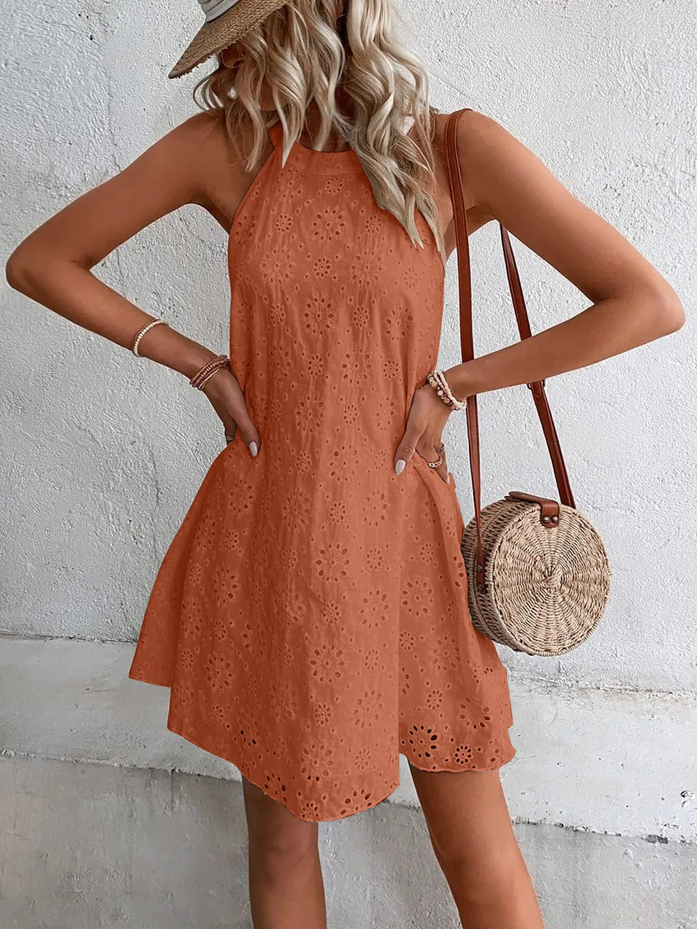 Caramel eyelet mini dress with halter neckline and flared, embroidered hem