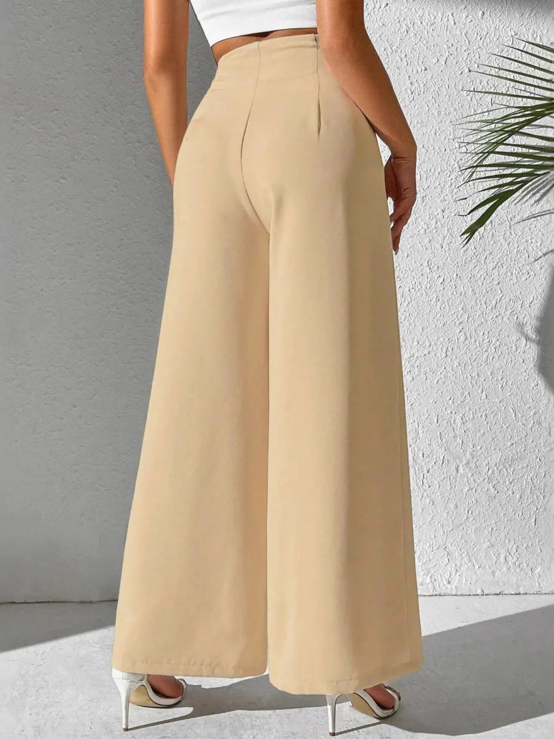 Beige high-waist wide-leg trousers with smooth front crease and wide legs
