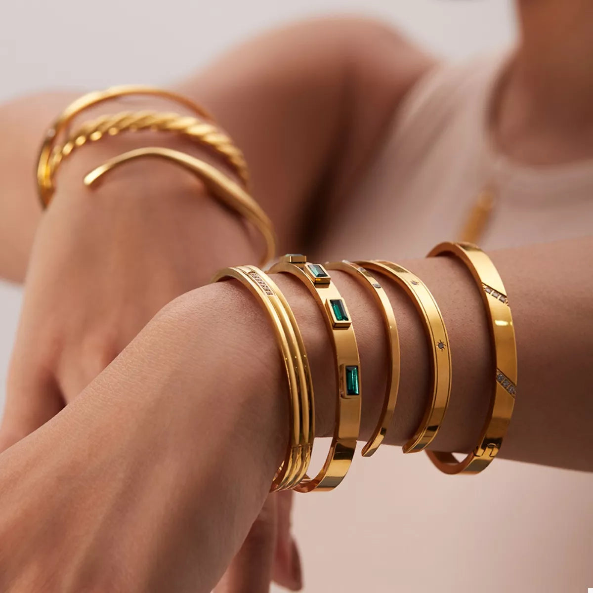 Gold-plated zircon cuff bracelet with green square insets and crystal border detail