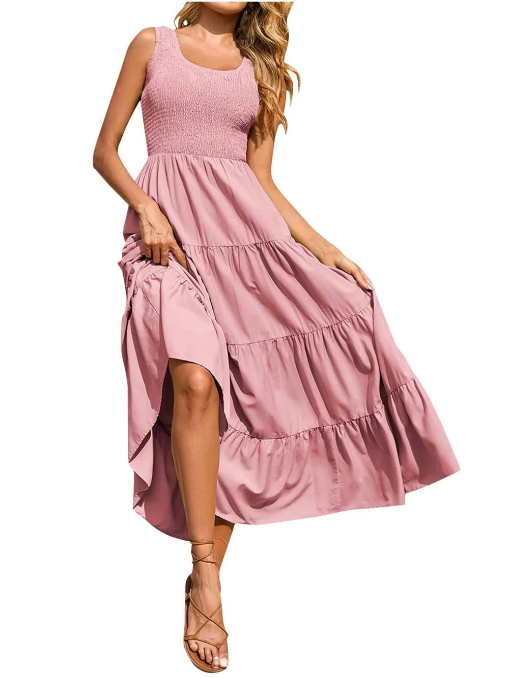 Tiered smocked wide strap dress in blush pink with tiered ruffle skirt.