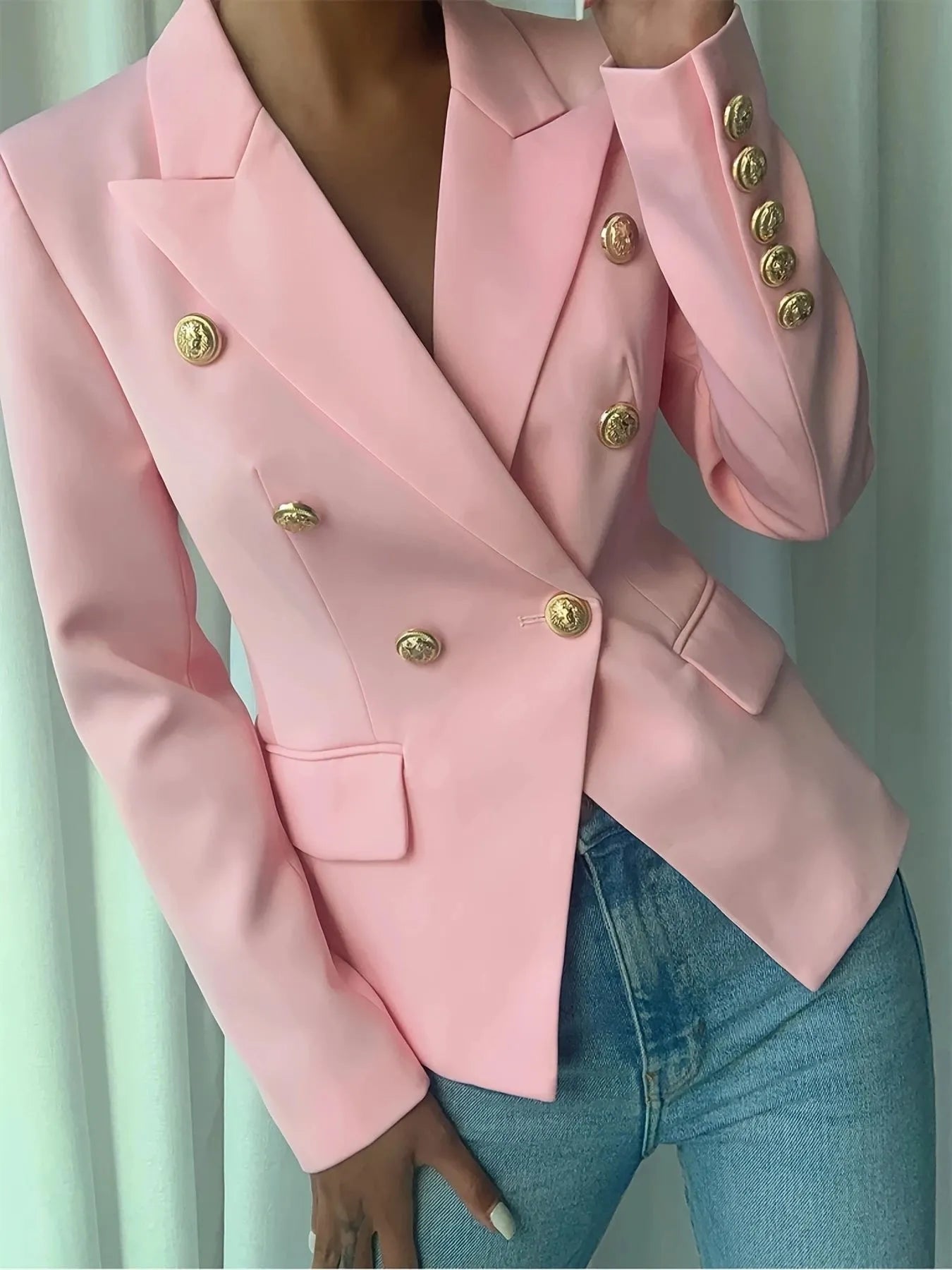 Pink double-breasted blazer with notch lapel and gold decorative buttons on sleeves