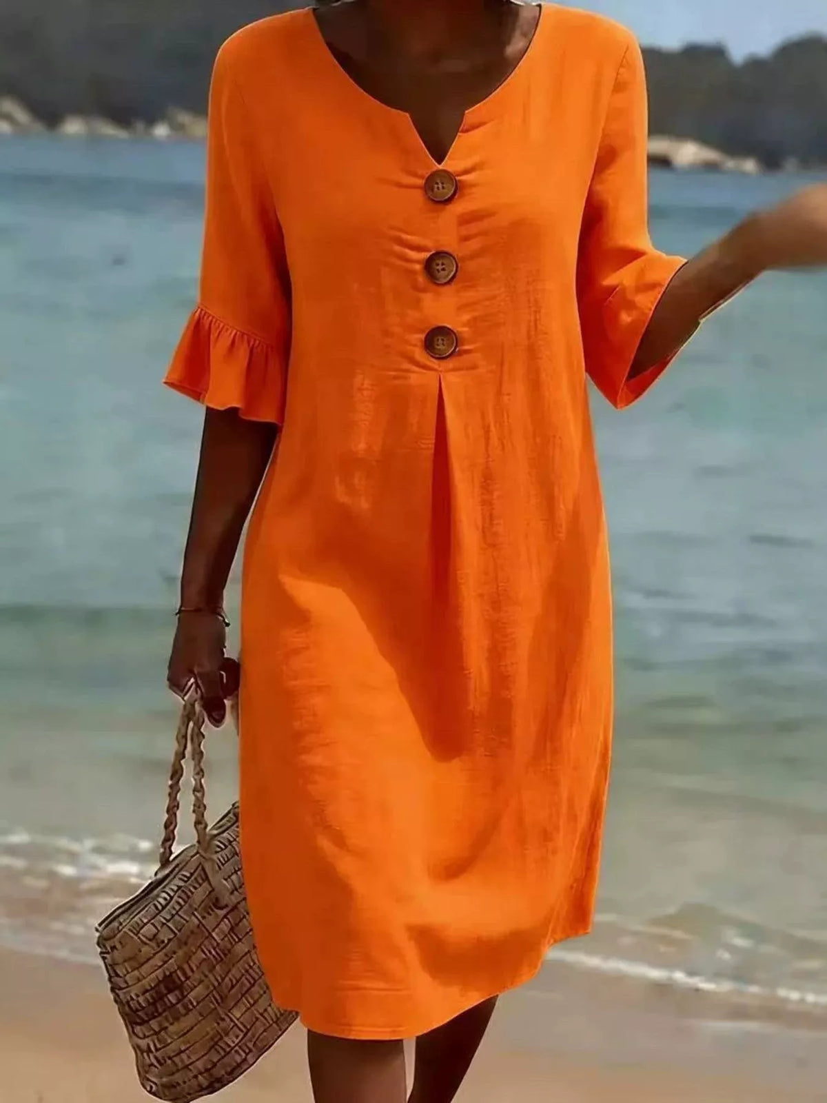 Orange button-front dress with ruffle sleeves and V-neck, three wood-look buttons