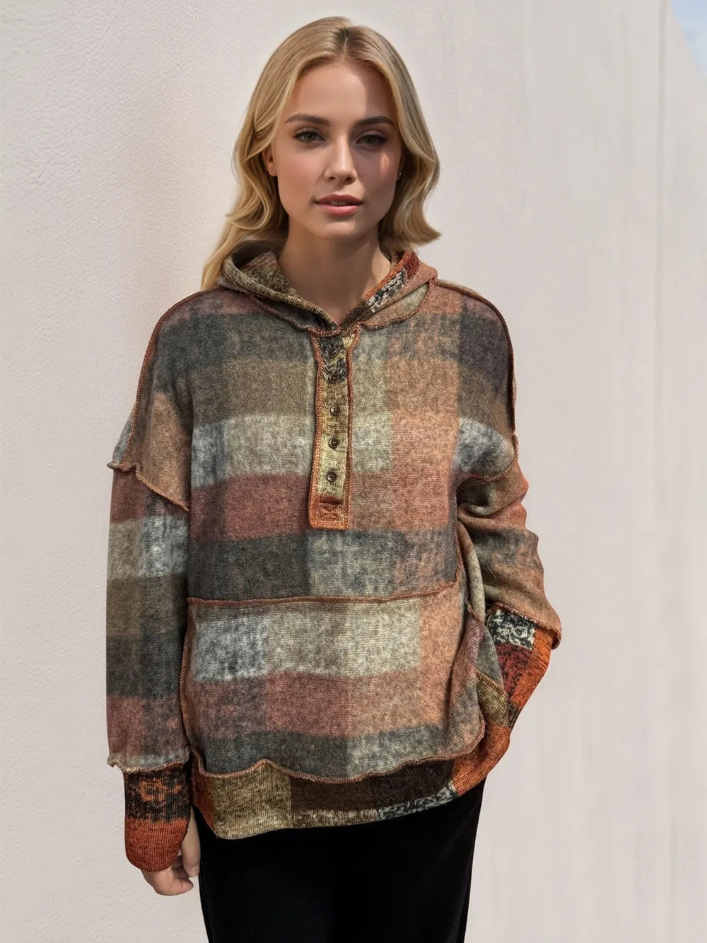 Plaid fleece hoodie with dropped shoulders, hood and quarter-zip placket, dark tones.