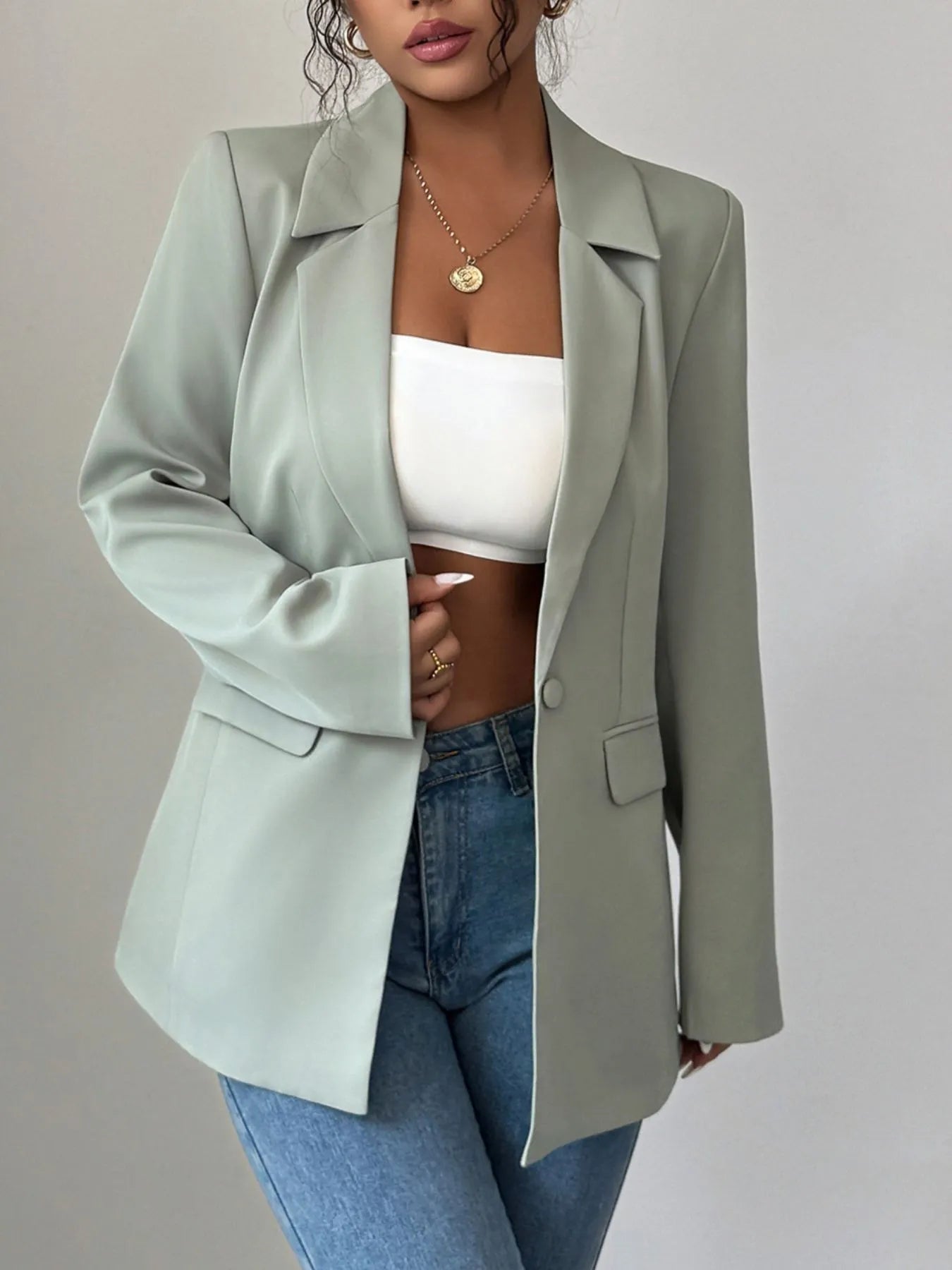 Light green one-button lapel blazer with notch collar and flap pockets