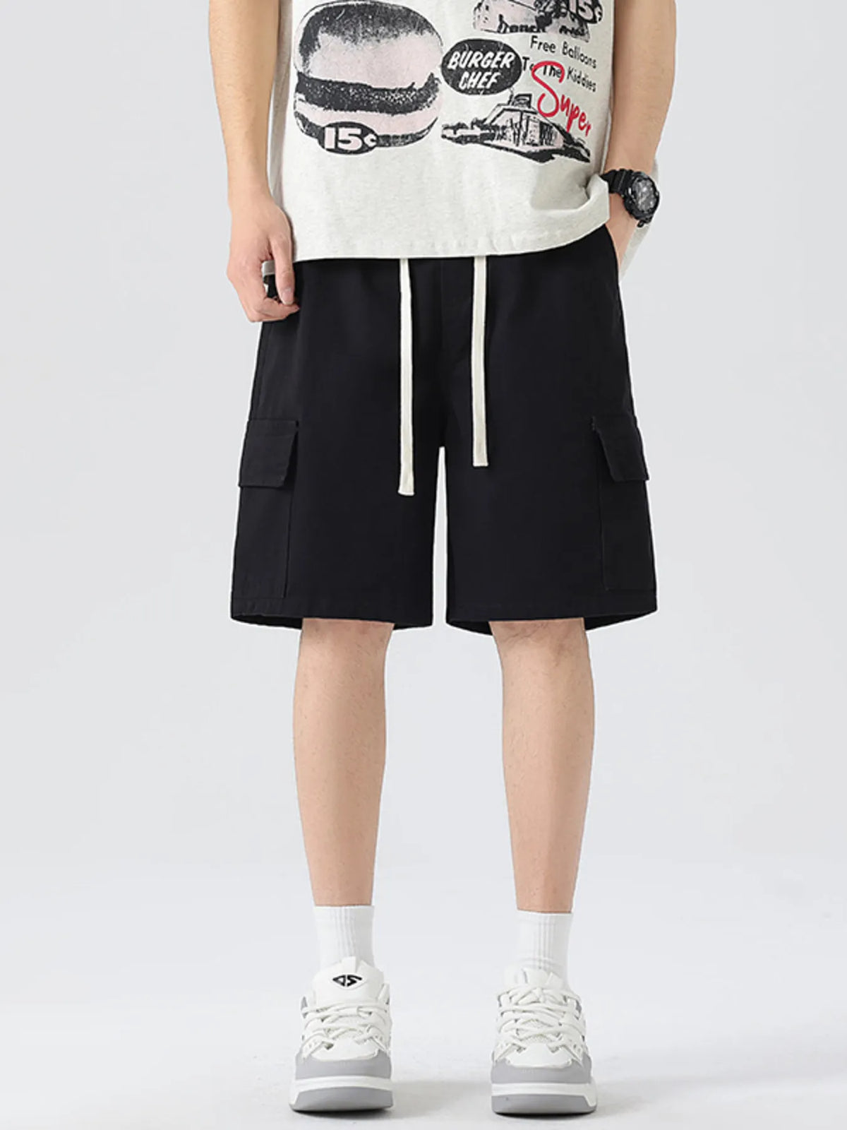 Men's black cargo drawstring shorts with side pockets and vertical white drawstring.