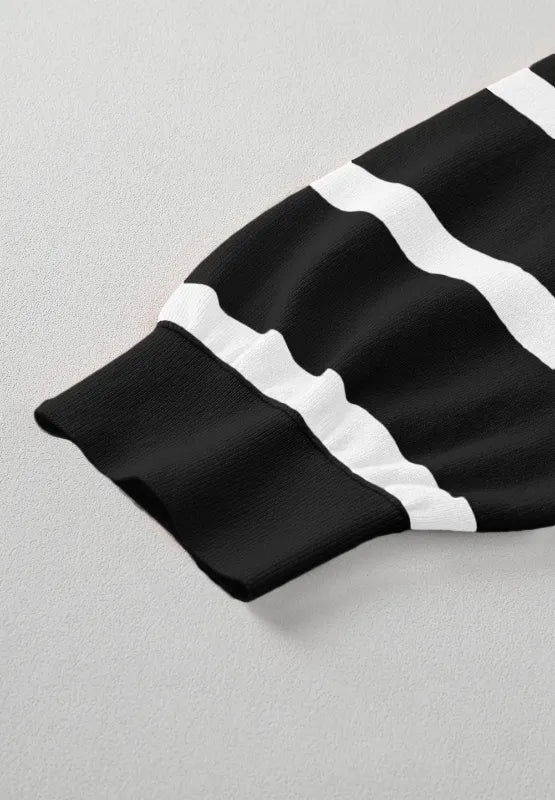 Sleeve cuff detail of contrast striped long sleeve sweatshirt, black and white stripe bands