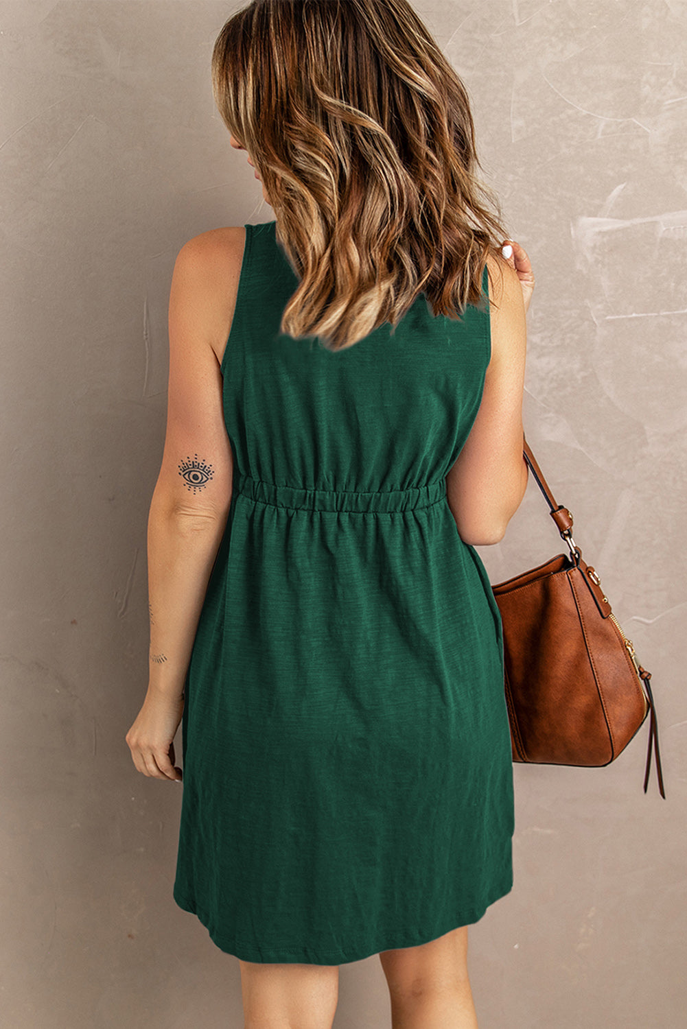 Green sleeveless button-front mini dress with gathered waist and button placket