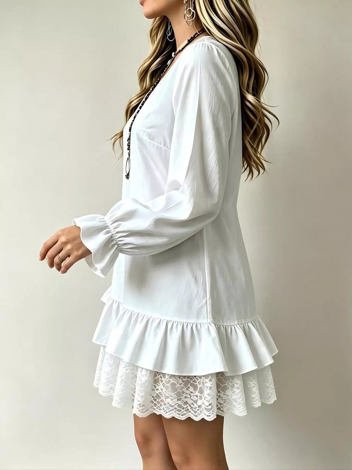 White V-neck flounce sleeve dress with tiered ruffle skirt and lace hem