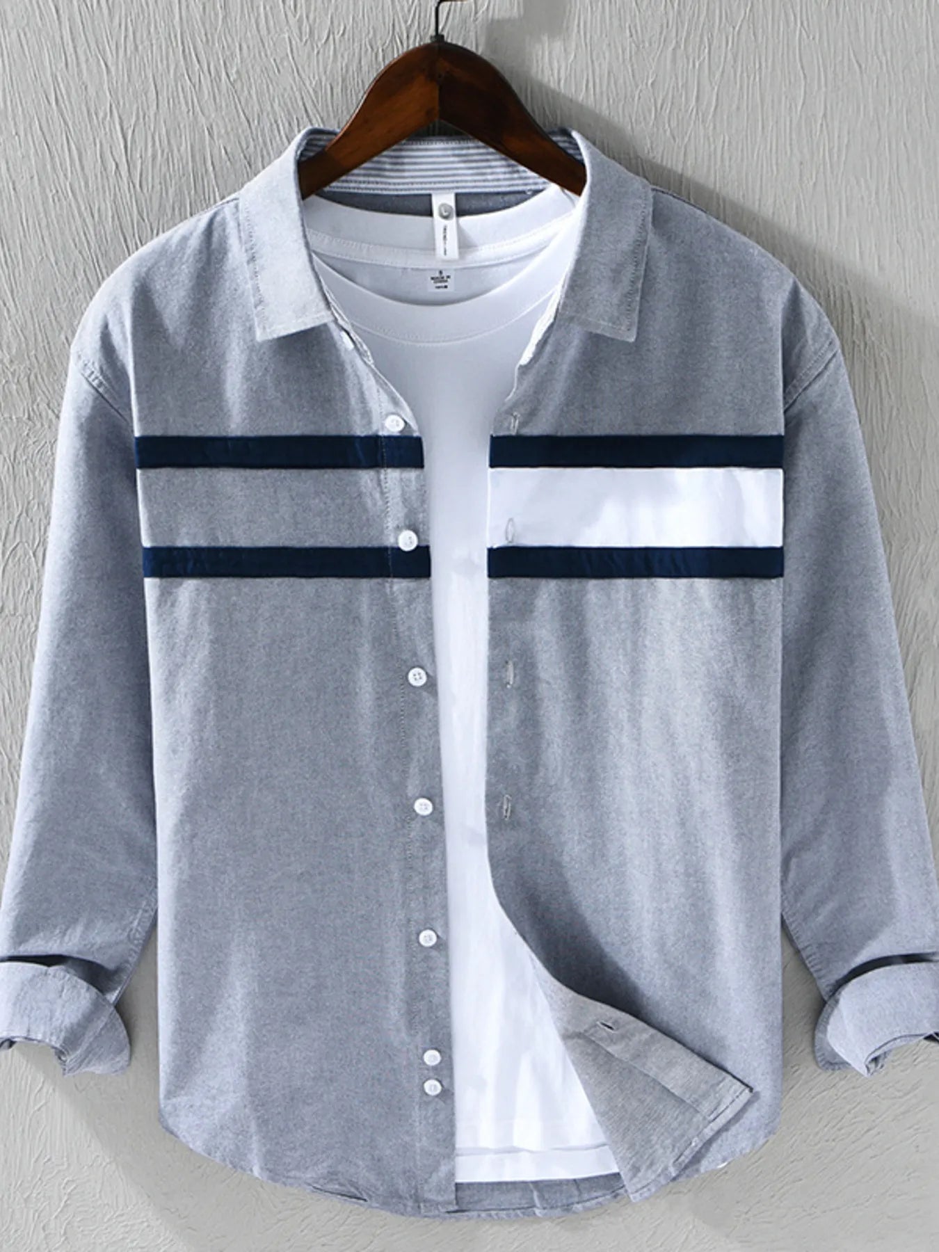 Gray striped button-down shirt with dark horizontal bands and front buttons