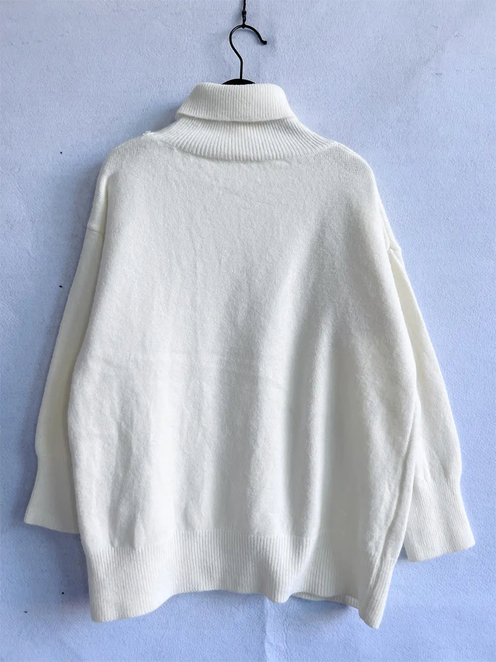 Turtleneck long-sleeve sweater in white, back view, ribbed hem and cuffs.