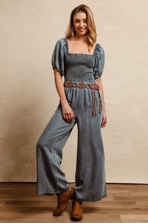 Denim jumpsuit with square neckline, smocked bodice, puff sleeves, wide-leg pants